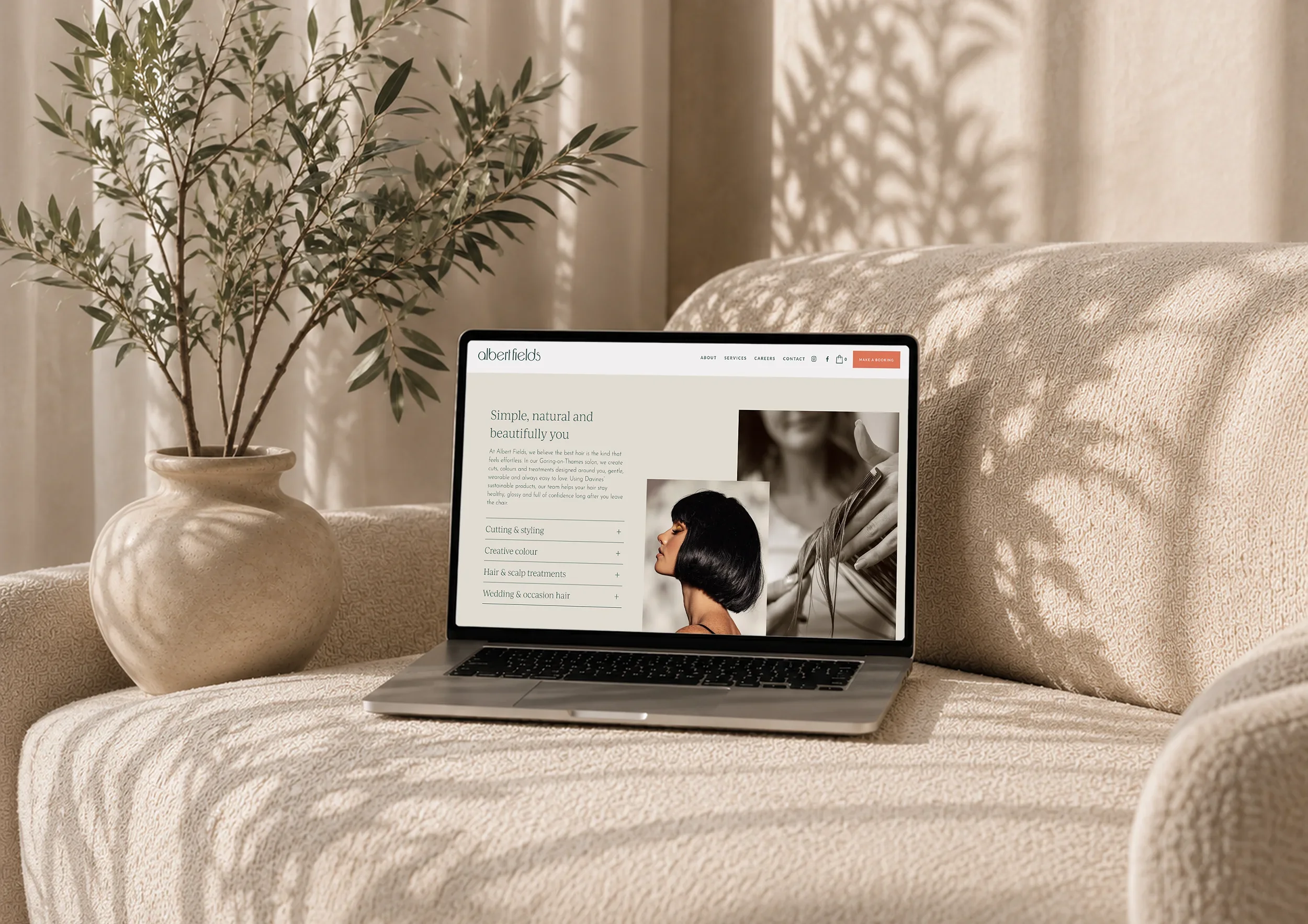 Albert Fields salon website displayed on a laptop, showing the services page and relaxed, natural brand aesthetic.