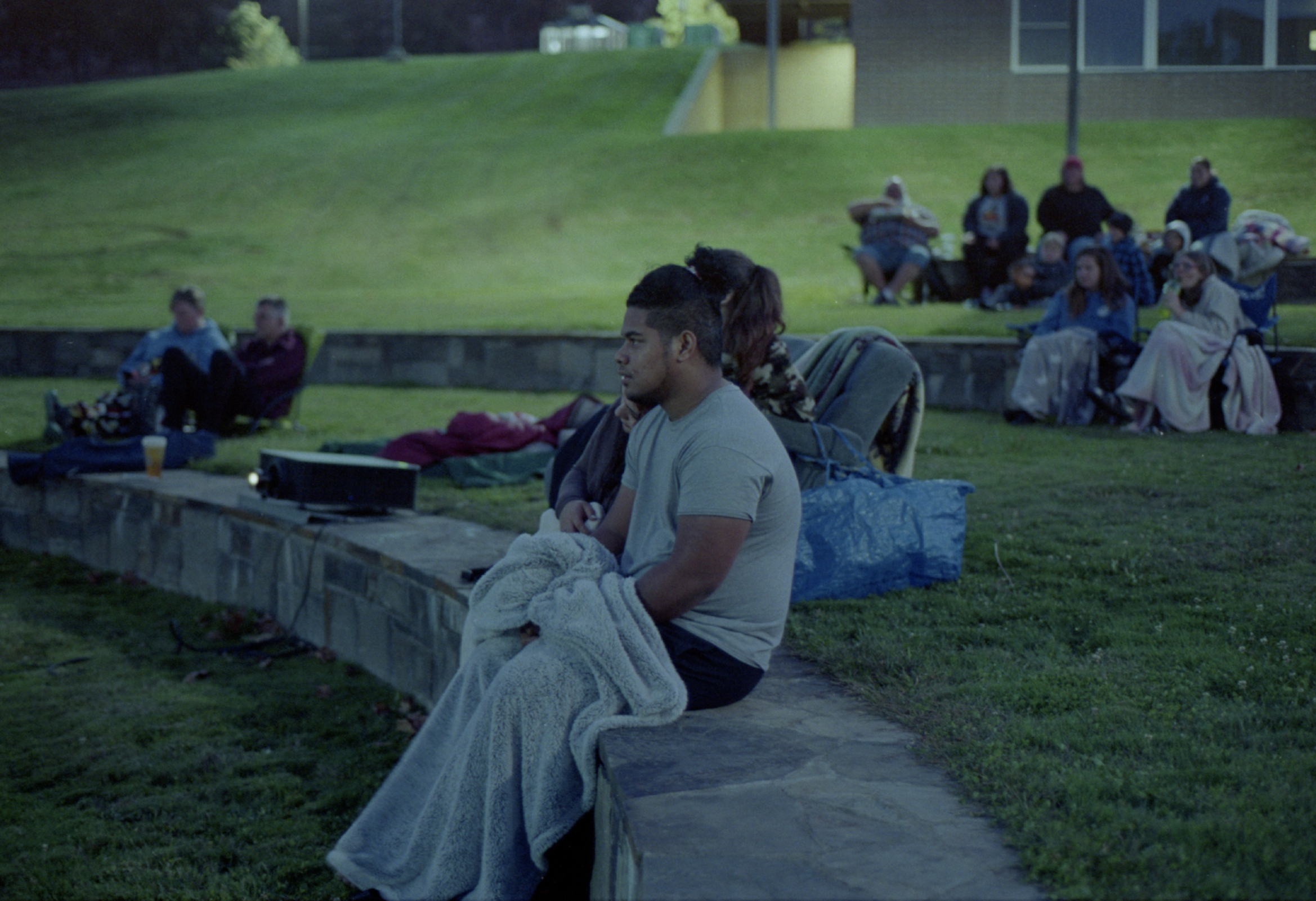 Students, Avery and Star bundled together in the cool autumn air for the movie in the amphitheater on Friday, Oct. 1, the last night of welcome week at Columbia Gorge Community College, The Dalles campus.   Disney’s Jungle Cruise was playing.                                                                          Photo by Ryan Lawrence