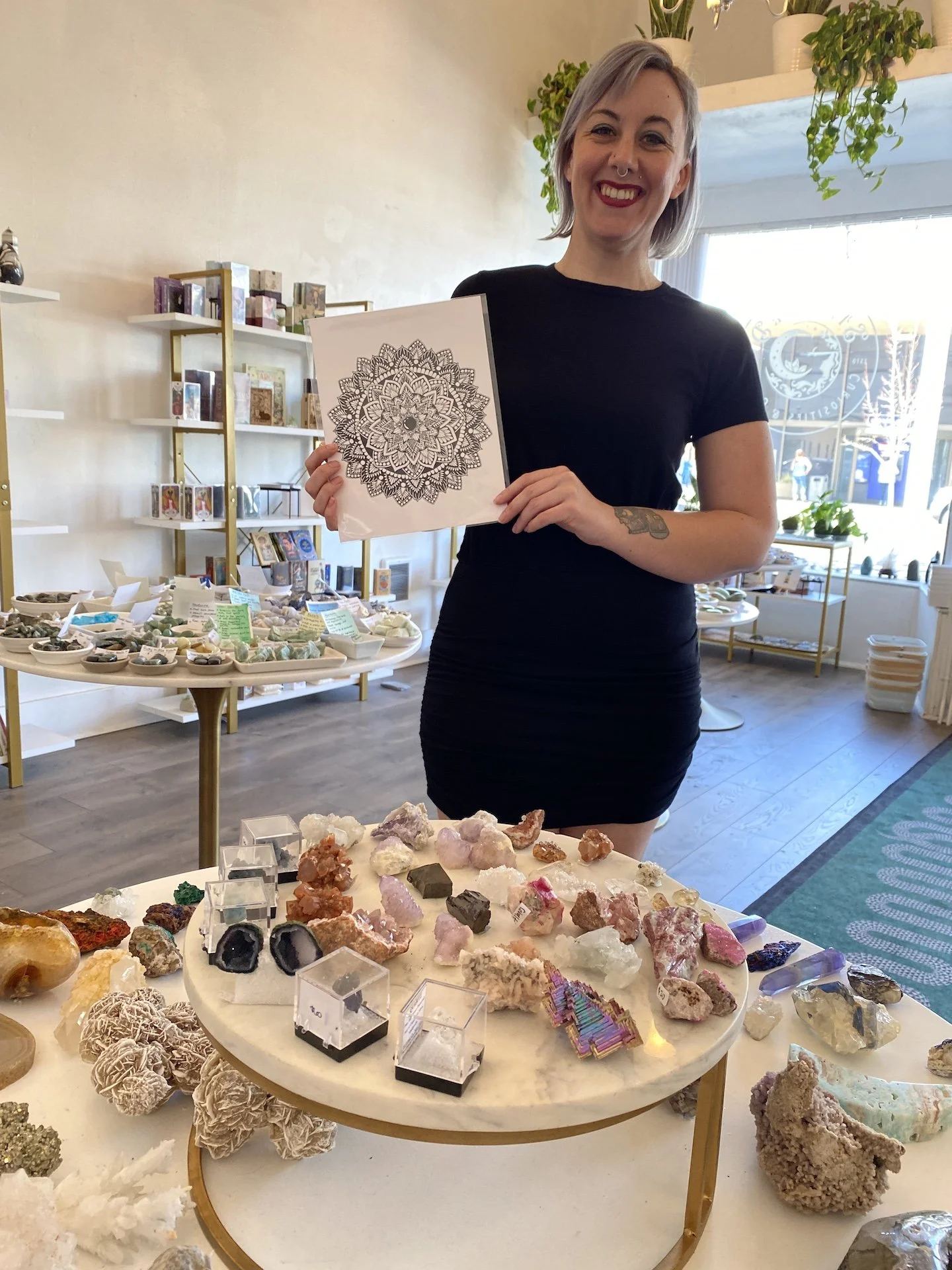 Amanda Lawrence holds up a Mandala created by a local artist. Visit Starseed Curiosities and Gifts tonight to meet the mandala artist. 