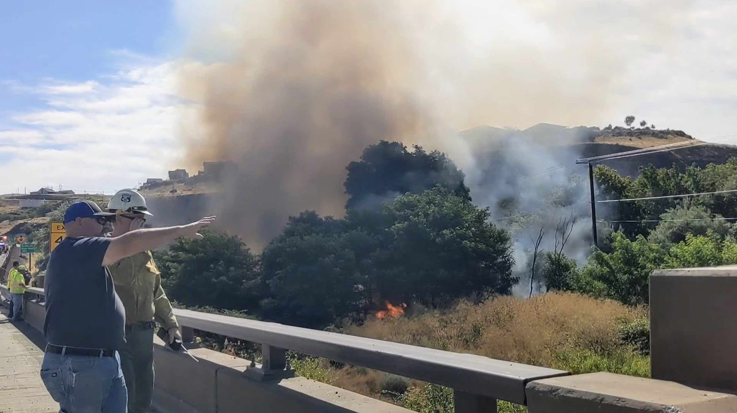 Firefighters strategize keeping the fire away from the AmeriTies plant. Photo Credit: Cole Goodwin