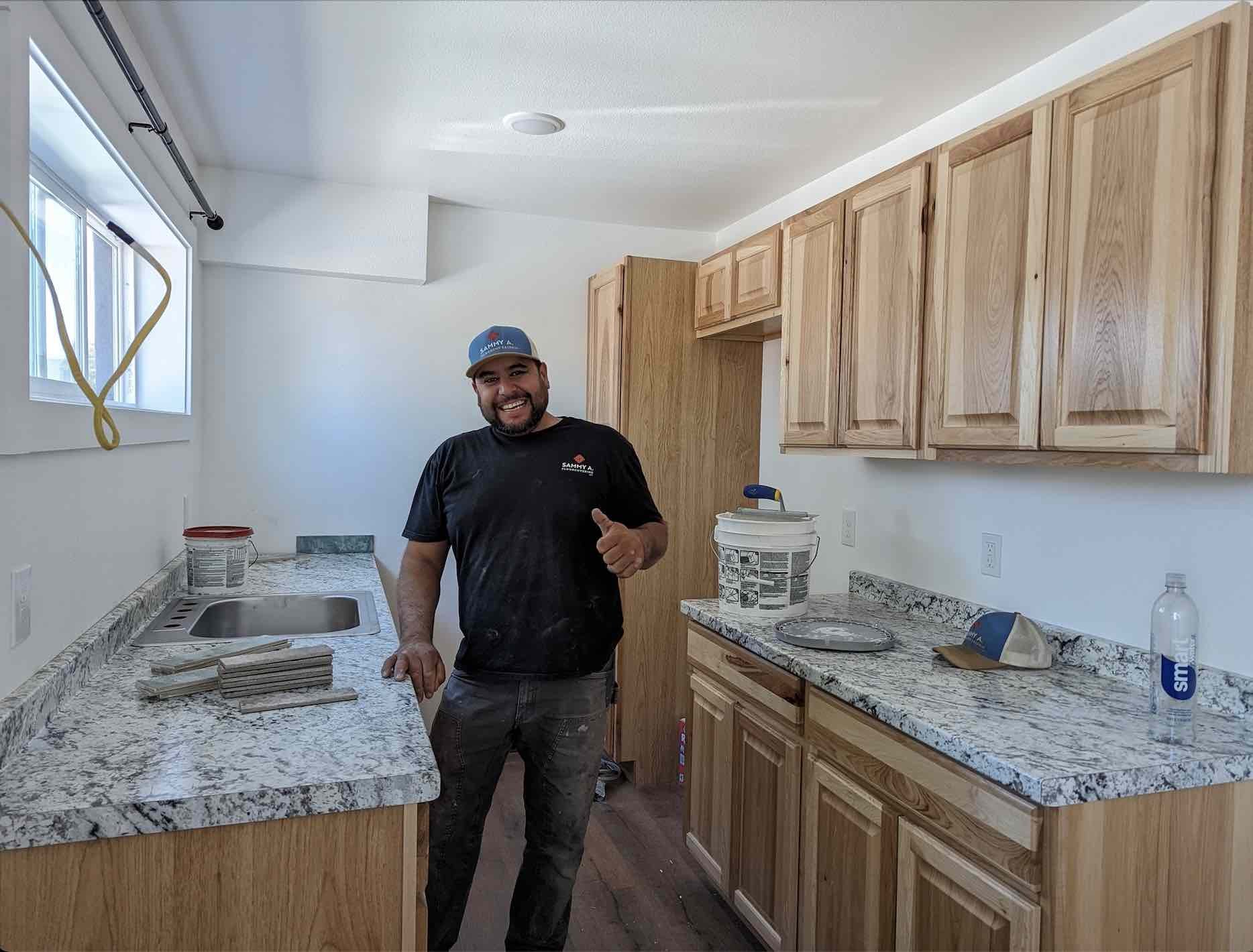 Sammy Alvarez, of Sammy A Floor Covering hard at work installing a kitchen in the on-site managers apartment. 