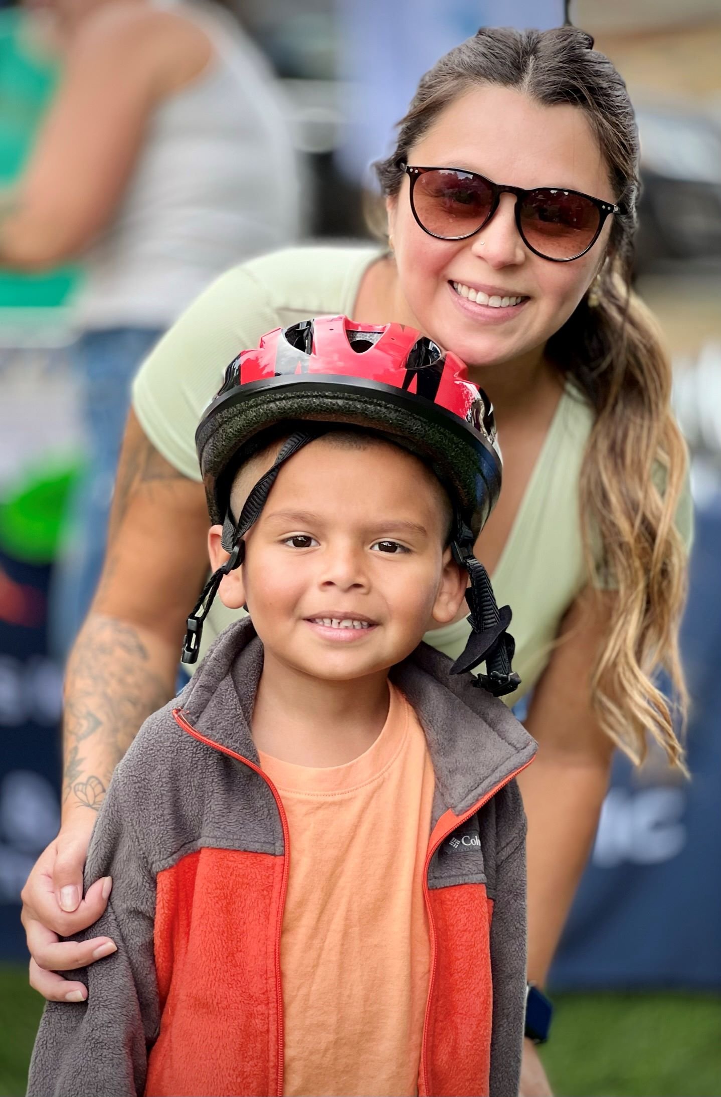 A little boy receives a new bicycle helmet from the Skyline Health Foundation.
