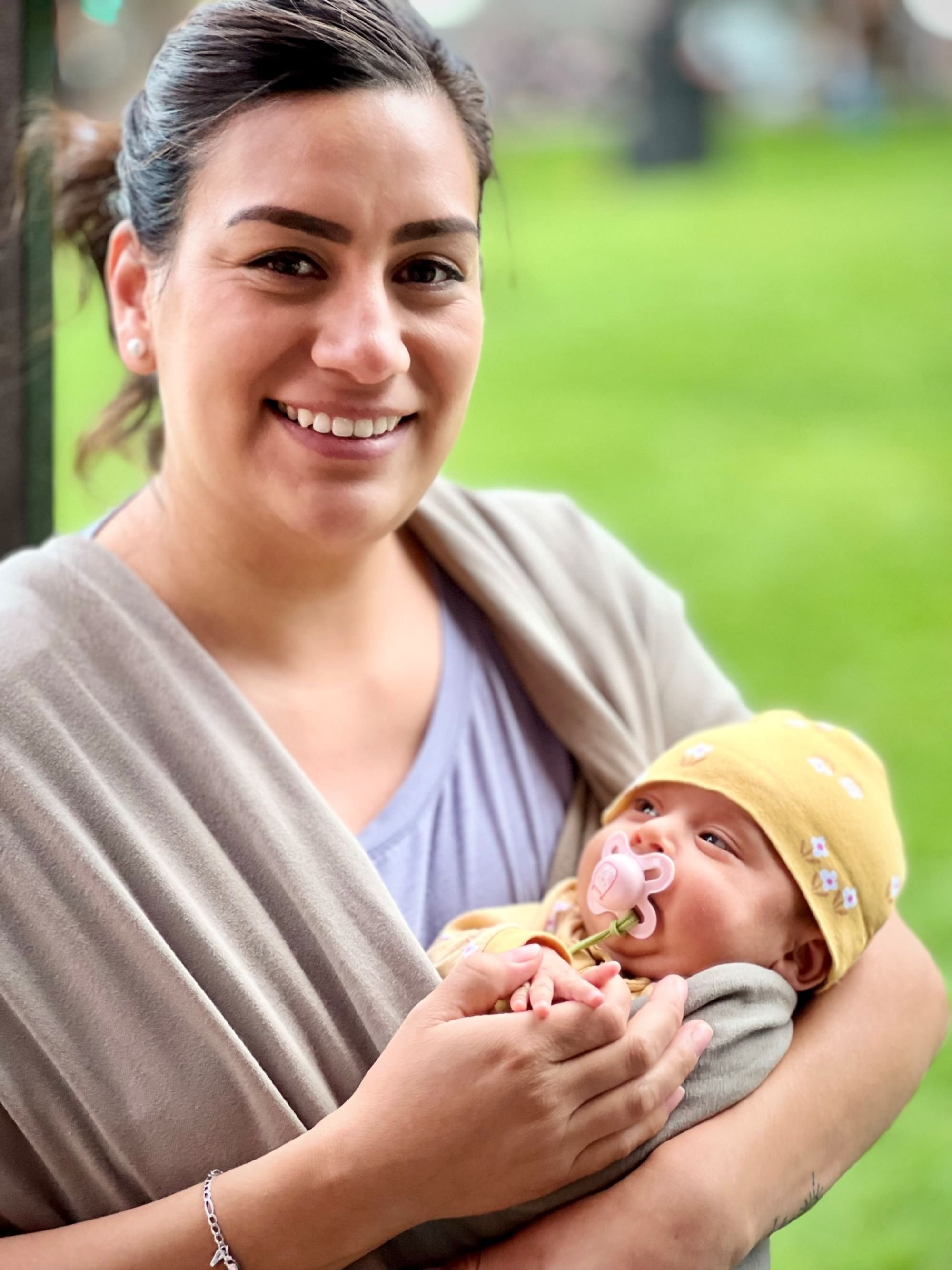 A local woman brings her new baby out for the fiesta. :)