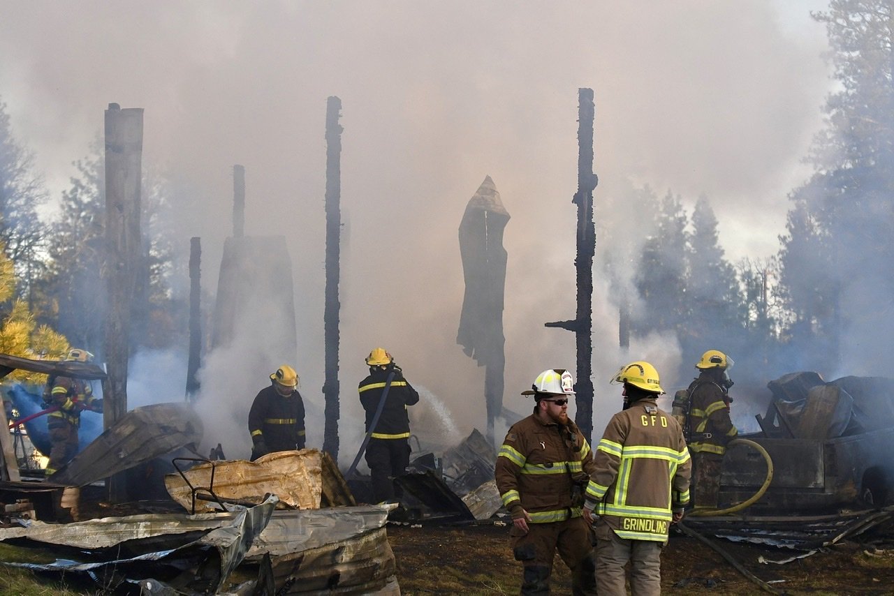  Volunteer Firefighters mop up after responding from multiple jurisdictios around Klickitat County to assist in extinguishing a structure fire Monday night at a large out building on Georgeville Rd. Photo: Mike Salsbury 