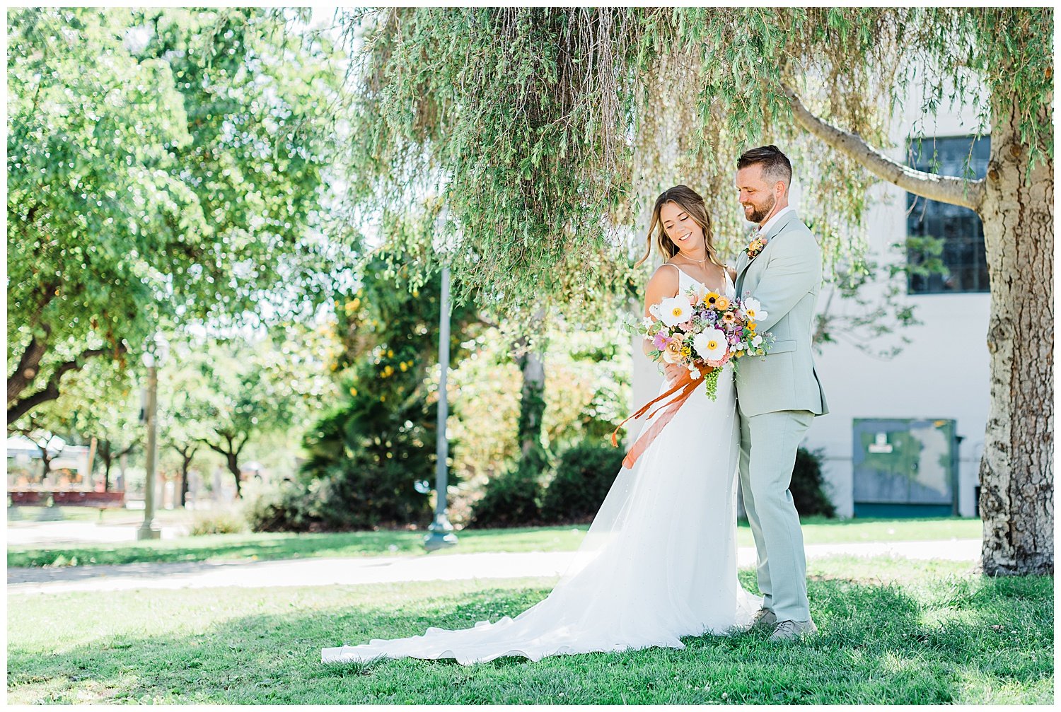 Bride and groom portrait under a willow tree