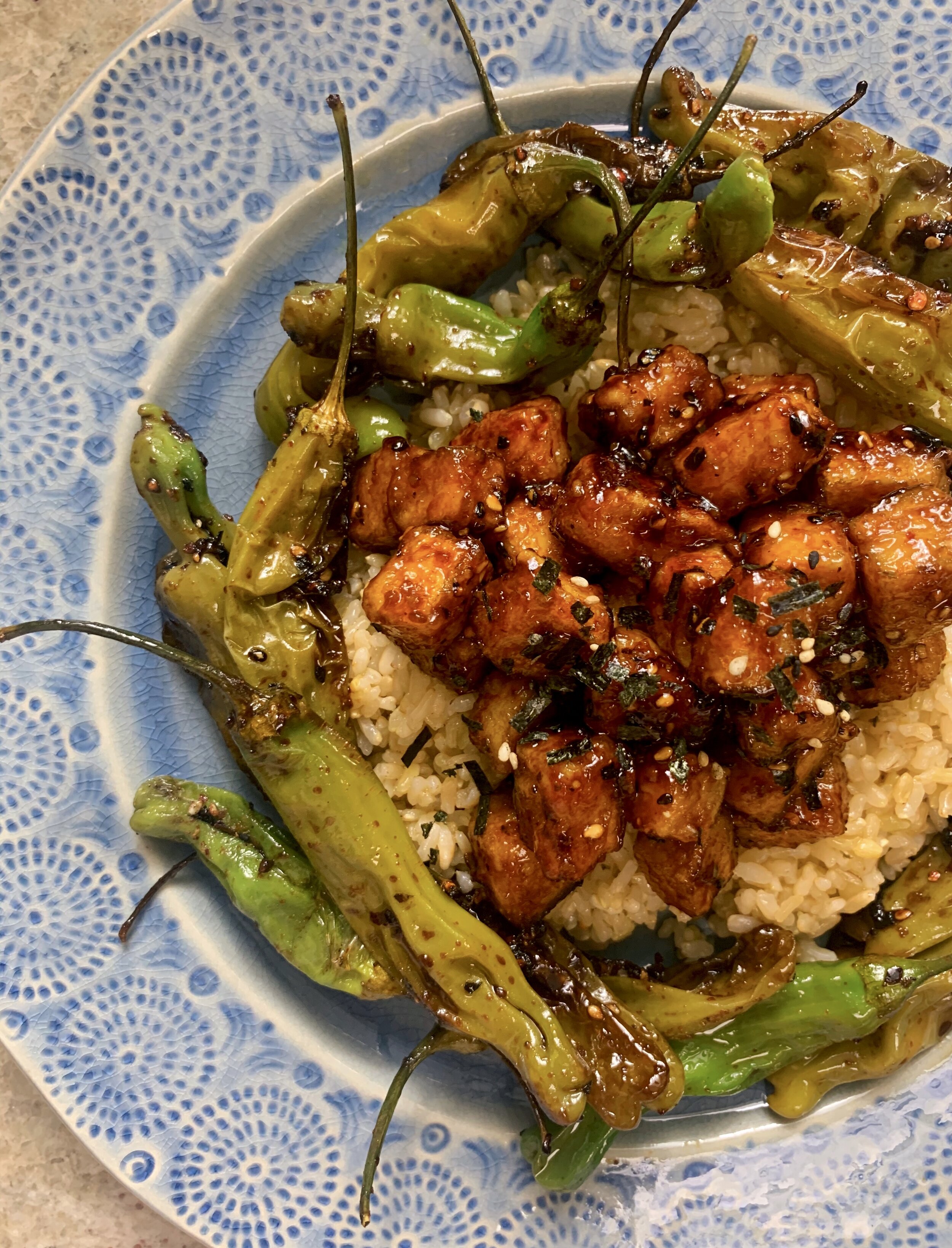 Crispy soy-glazed tofu with shishito peppers and brown rice (vegan)