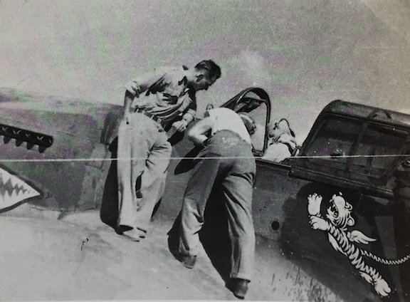  Frank and another crewmember help prepare pilot Edwin Conant for a mission 