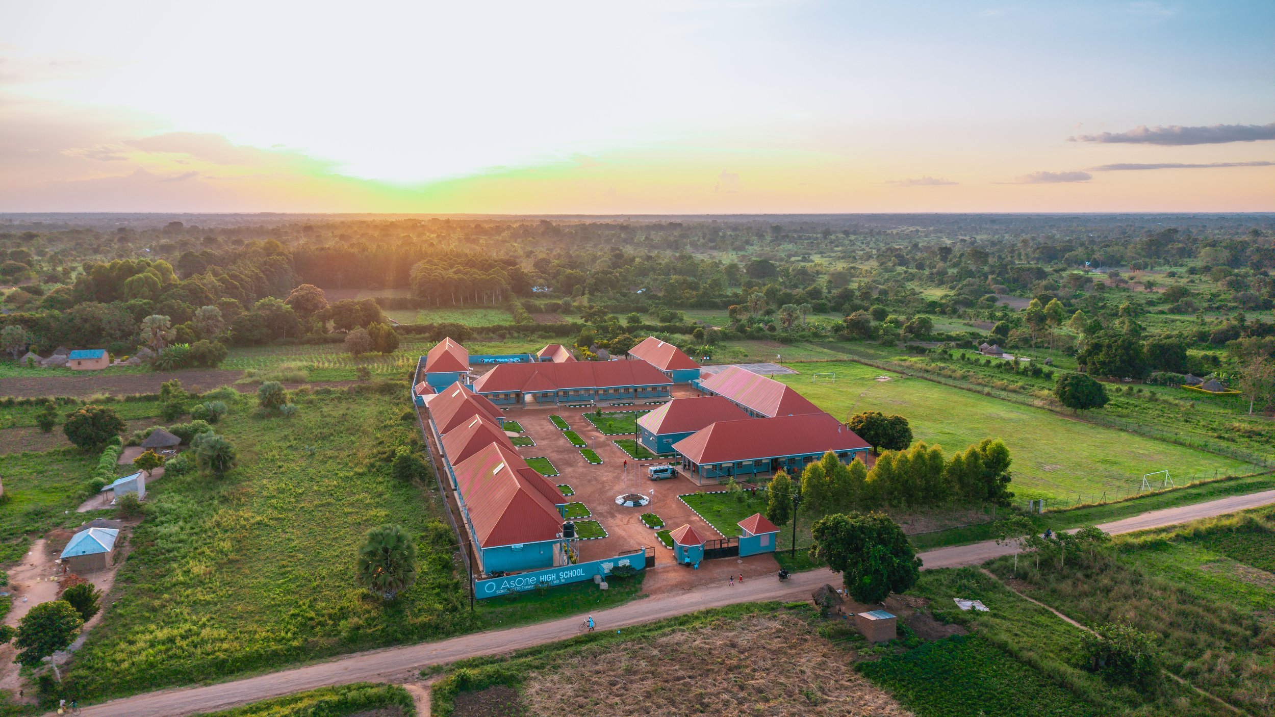 Aerial drone view of AsOne Nursery & Primary School, Pallisa, at sunset