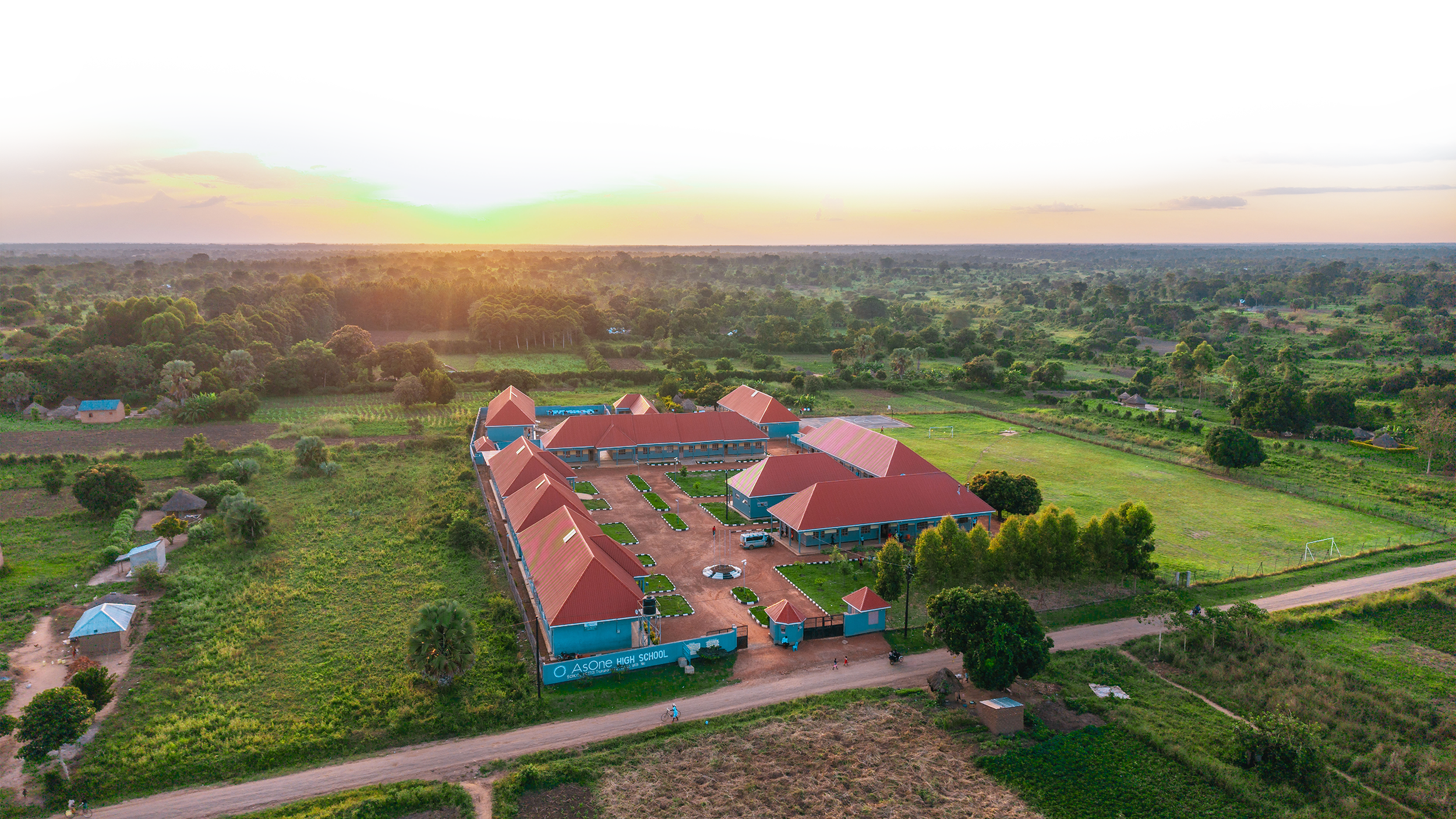 Aerial drone view of AsOne Nursery & Primary School, Pallisa, at sunset
