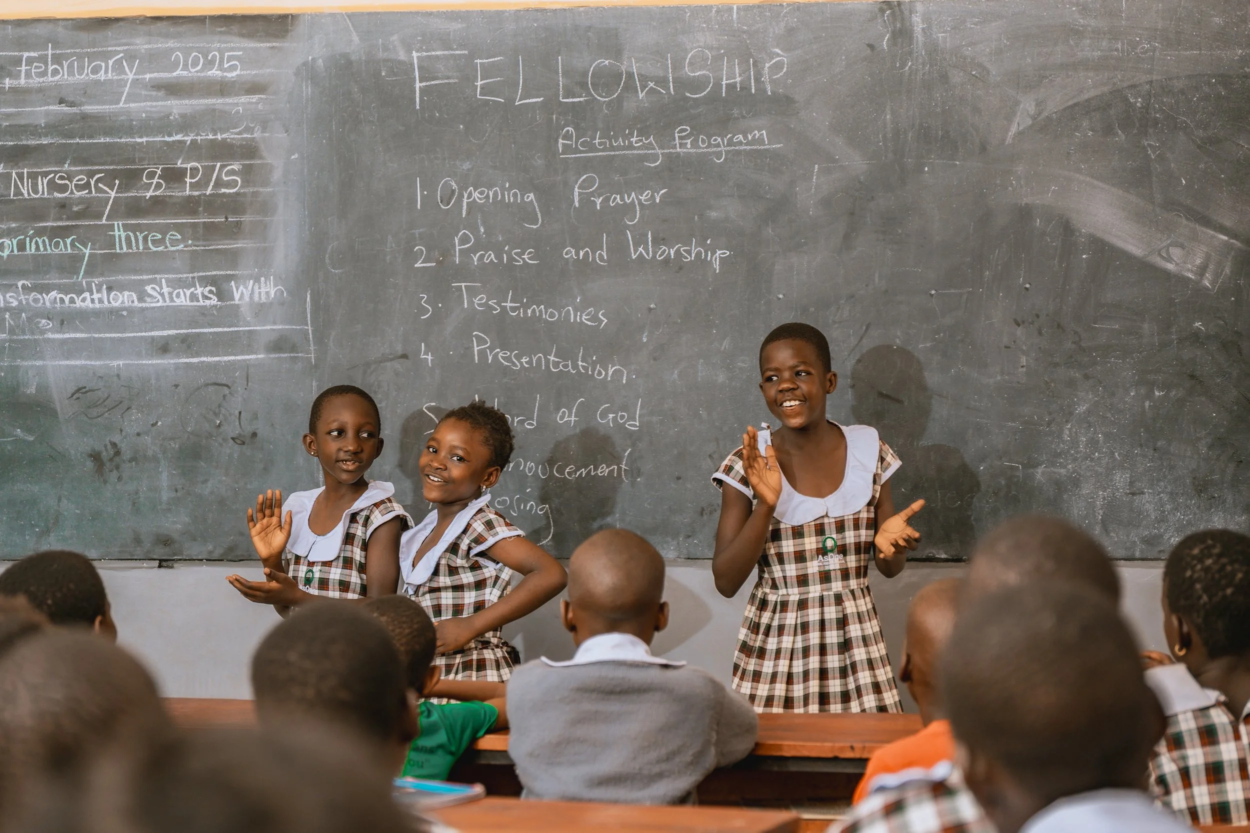 AsOne Nursery & Primary School, Serere students clapping and singing during a classroom fellowship program