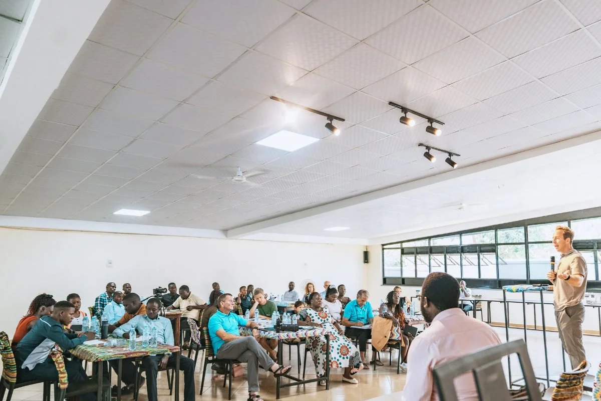 AsOne staff and leadership seated at tables during a leadership retreat indoors