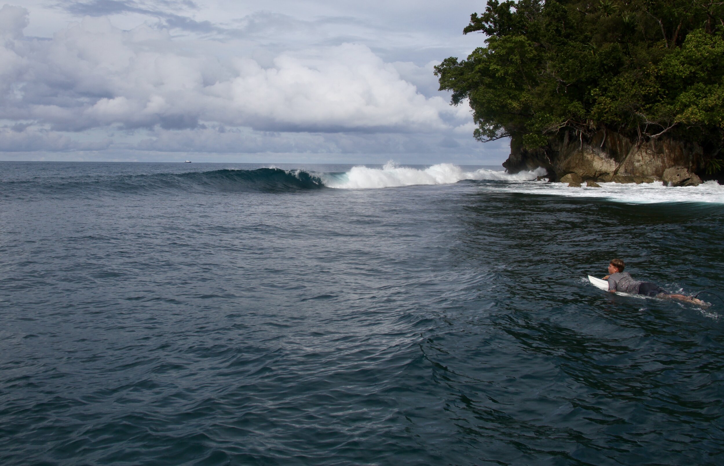  Alex Baker paddles out at a previously unsurfed right somewhere in Melanesia Photo: Martin Daly  
