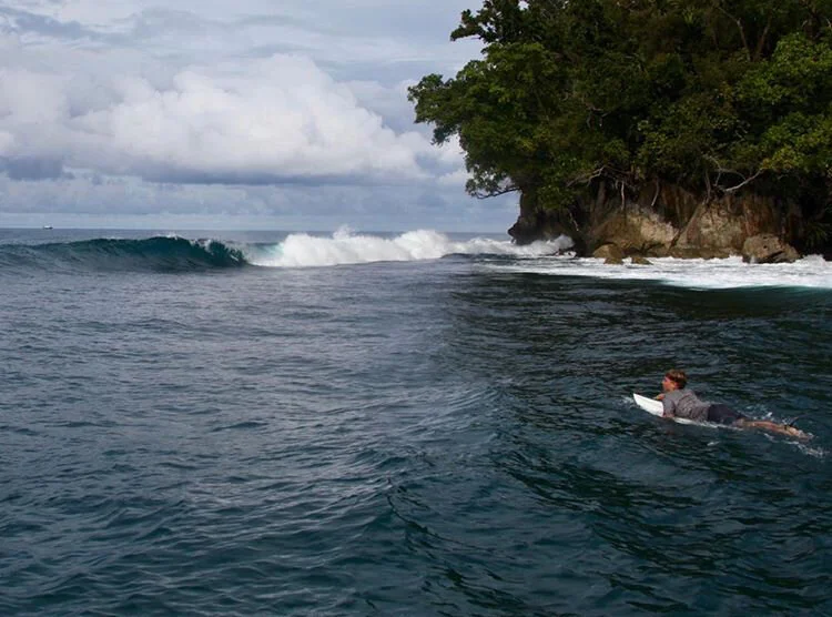 A 14-year-old Alex Baker, son of the author, paddles out at a previously unsurfed break during a trip on the Indies Trader Photo: Martin Daly