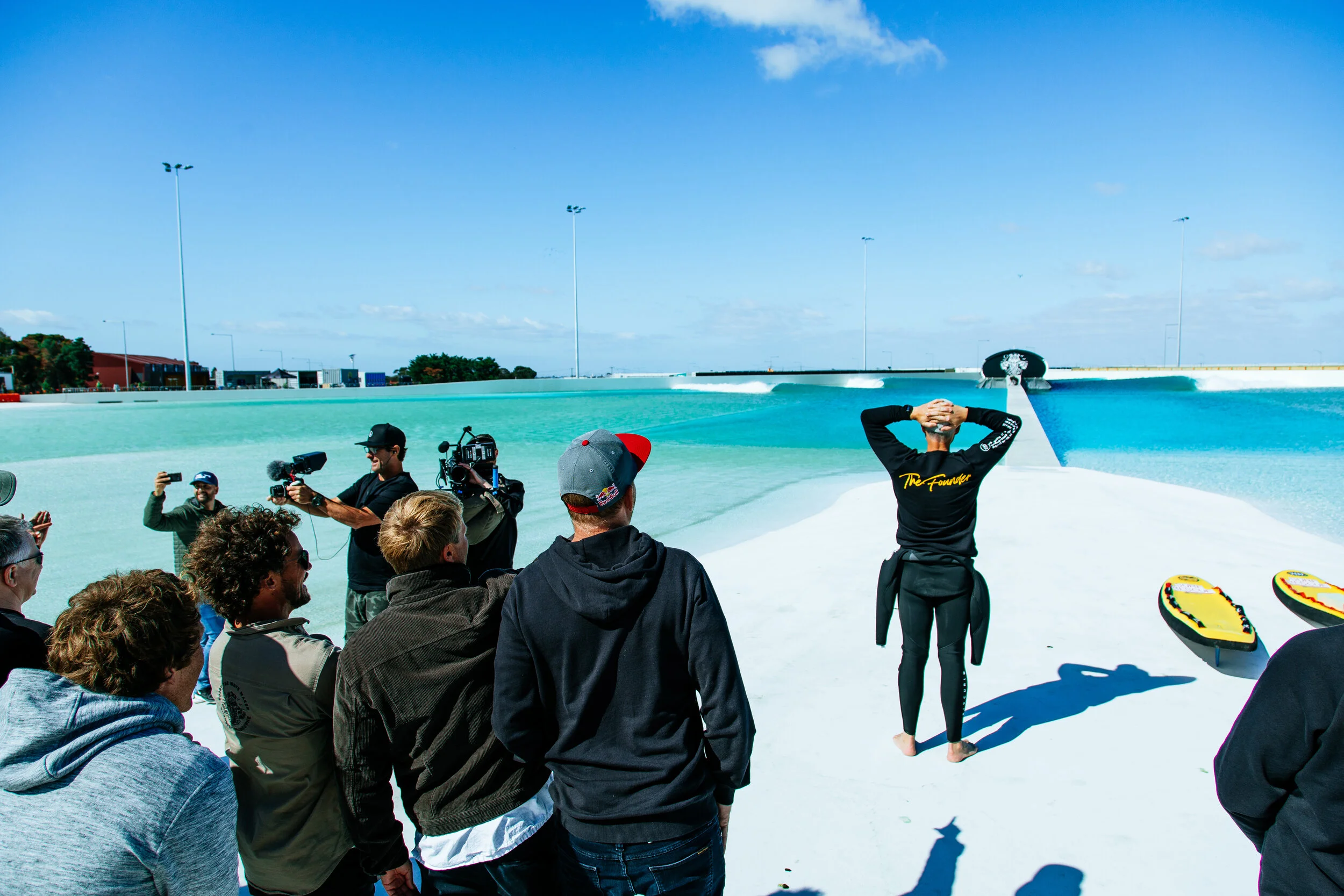 No pressure. Andrew watches a full-size set roll through the UrbnSurf wave park for the first time as he prepares to paddle out
