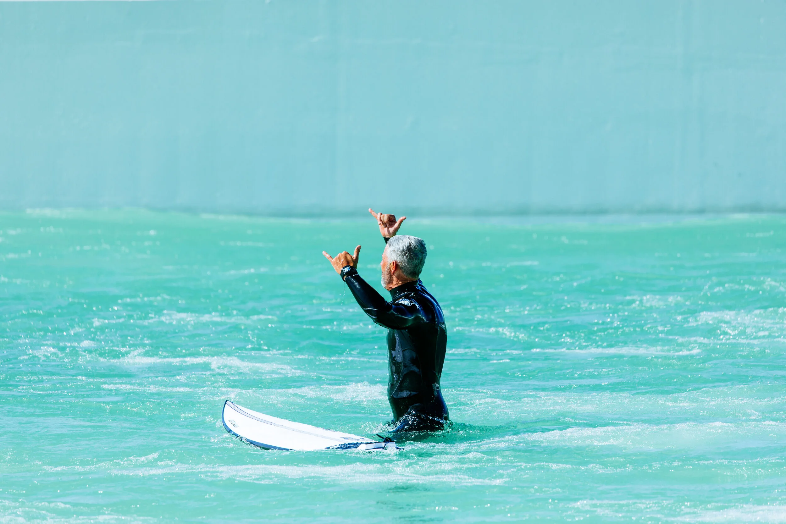 Double shakas after the first successfully ridden wave