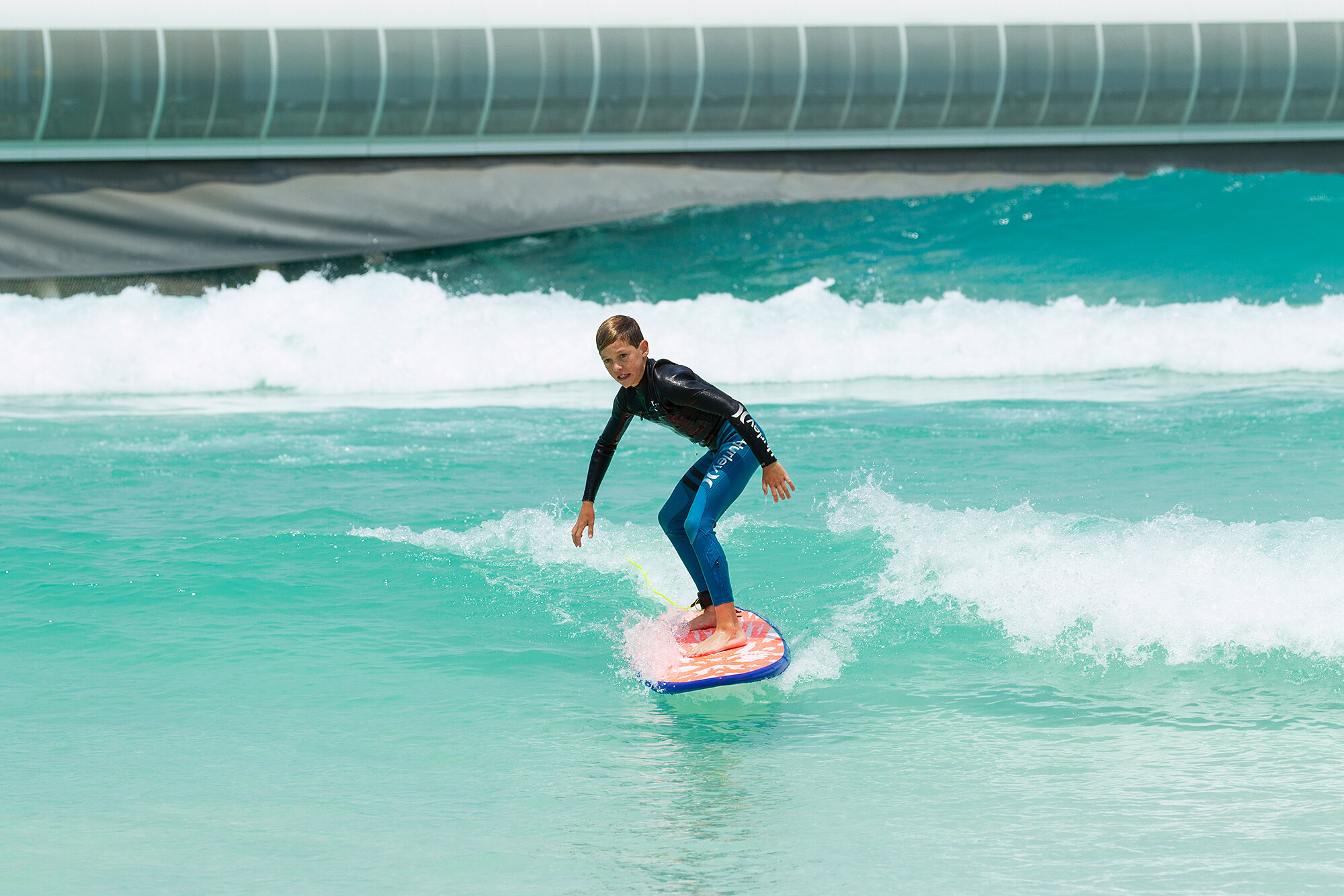   Andrew’s son Lochie has a crack at the Bay to celebrate the first day of surfing at UrbnSurf  