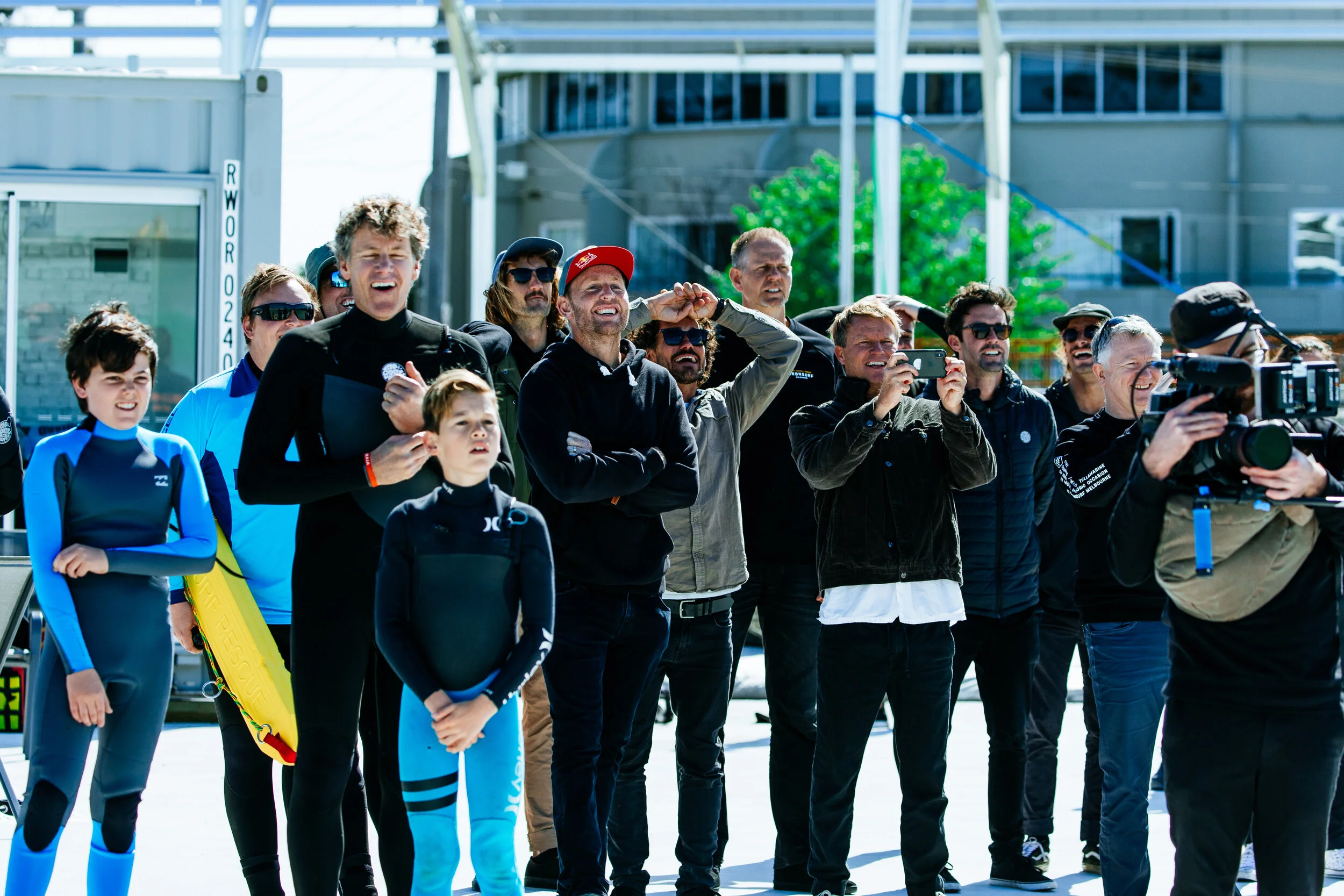 A crowd including Taj Burrow and Mark Mathews gather to watch the first wave ridden at UrbnSurf
