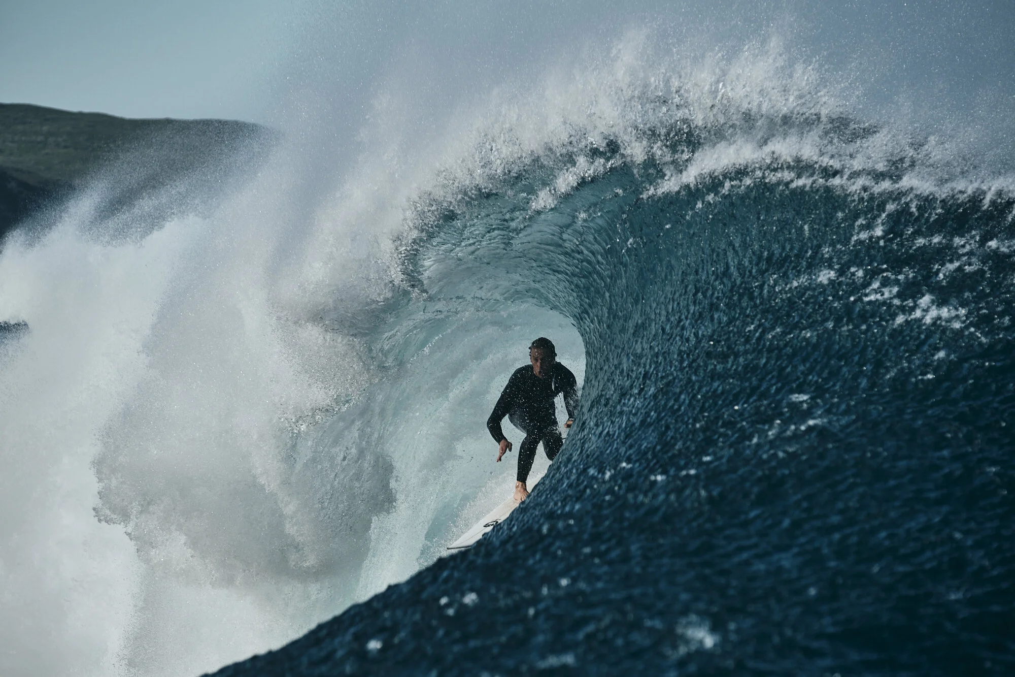 Kalani Ord slots into a clean bazza at one of the region's offshore reefs in front of his proud dad's lens