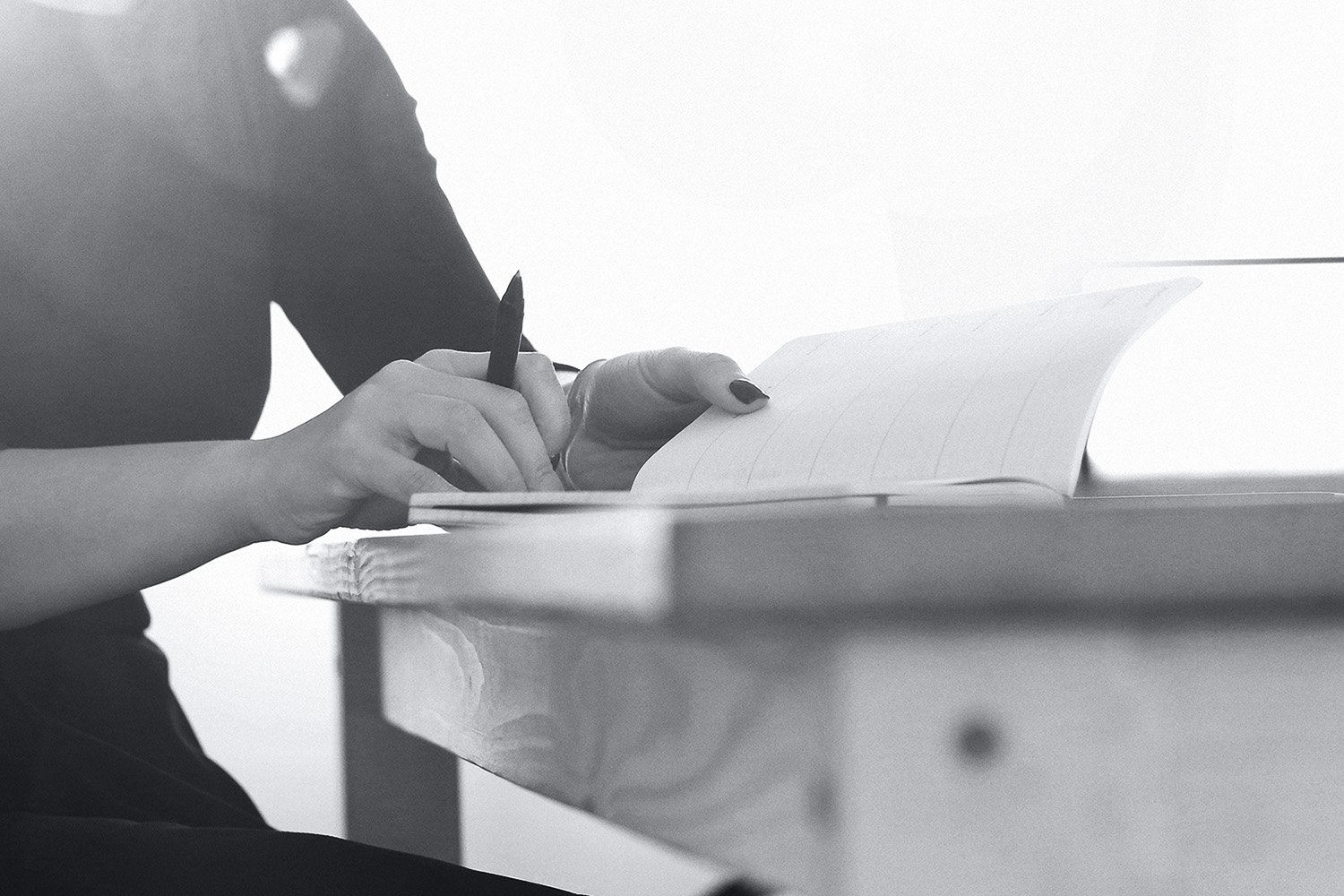 Designer taking written notes at client branding meeting at Tandem’s design studio in Fremantle