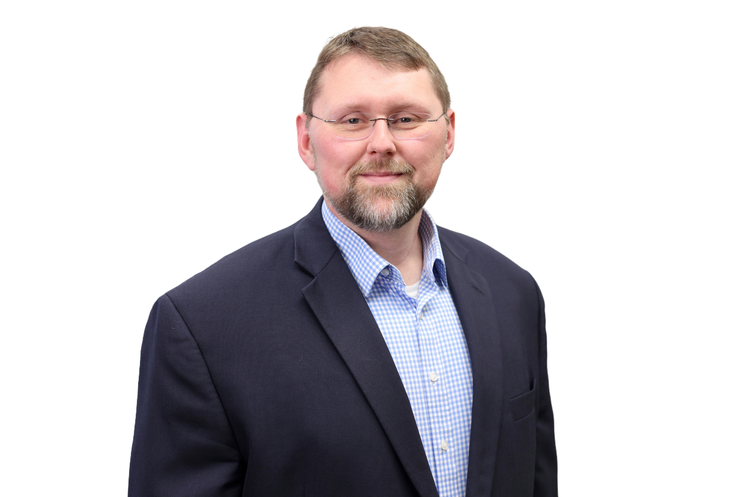 Assistant Director, Jeremiah Miller, in glasses and a suit with a blue checked shirt on a white background.