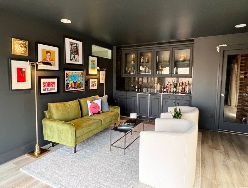 Before and after of my client&rsquo;s bar/lounge space! We color matched the existing bar cabinetry and covered the rest of the room with it for a bold and moody vibe. The dark color was a perfect backdrop for their eclectic art collection and the gr