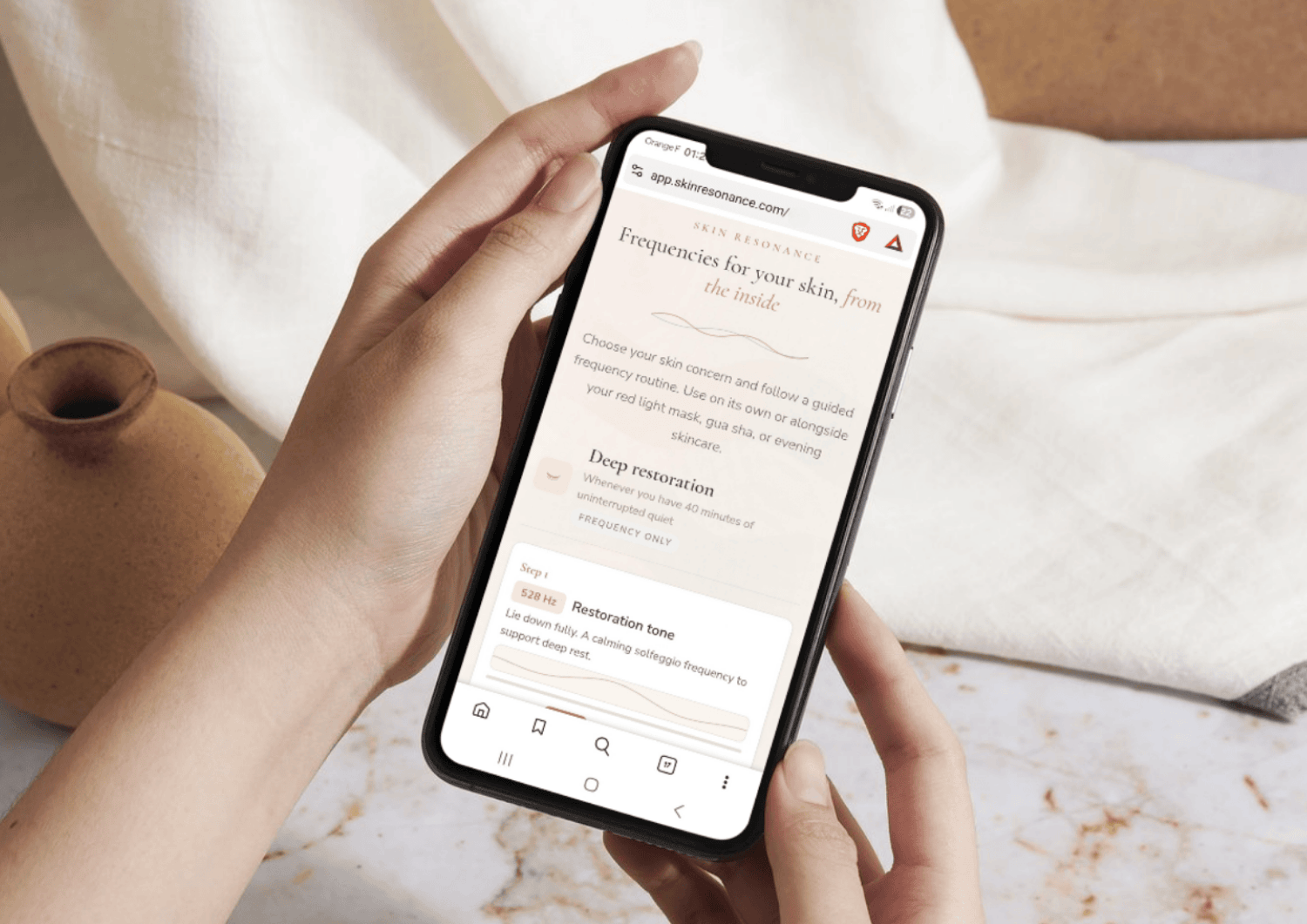 The Skin Resonance app running on a phone, showing the Deep Restoration routine with a 528 Hz solfeggio frequency step