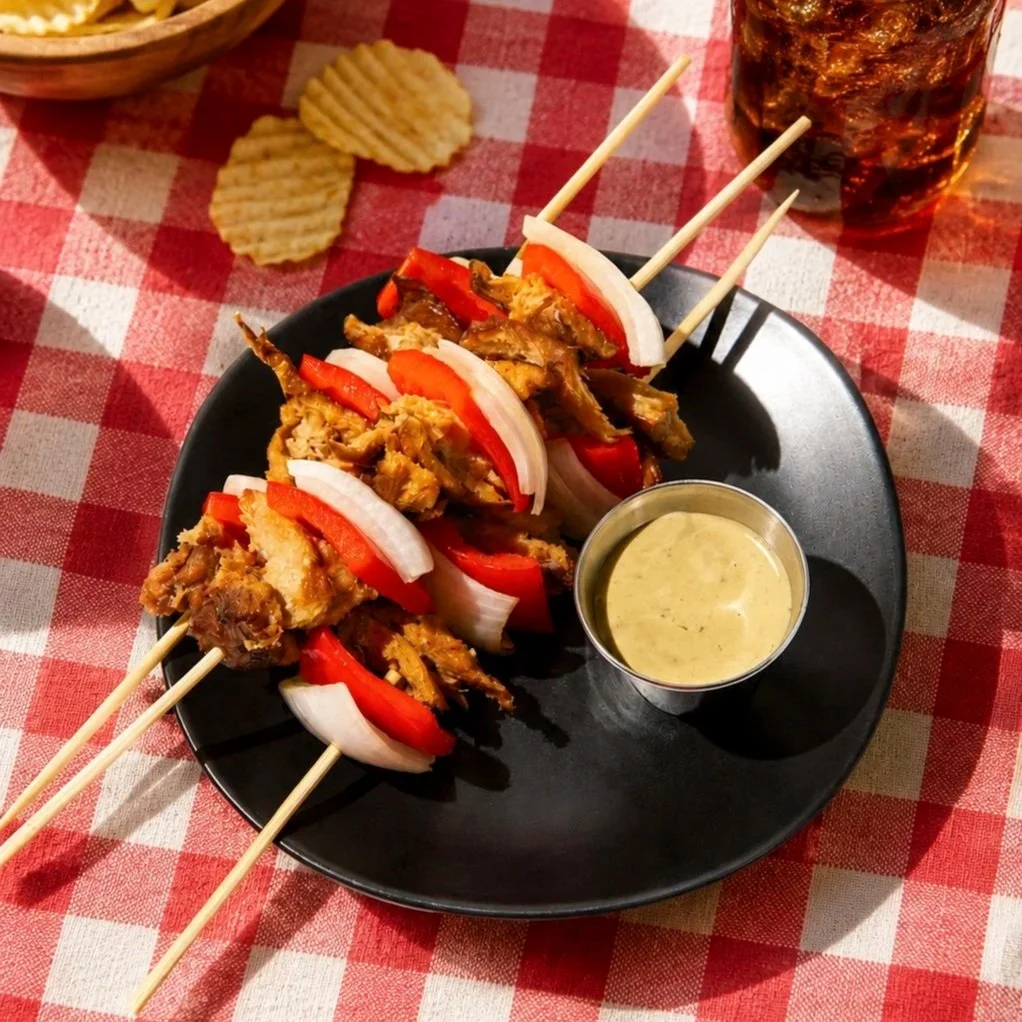 blackbird grilled seitan on picnic tablecloth with chips and soda