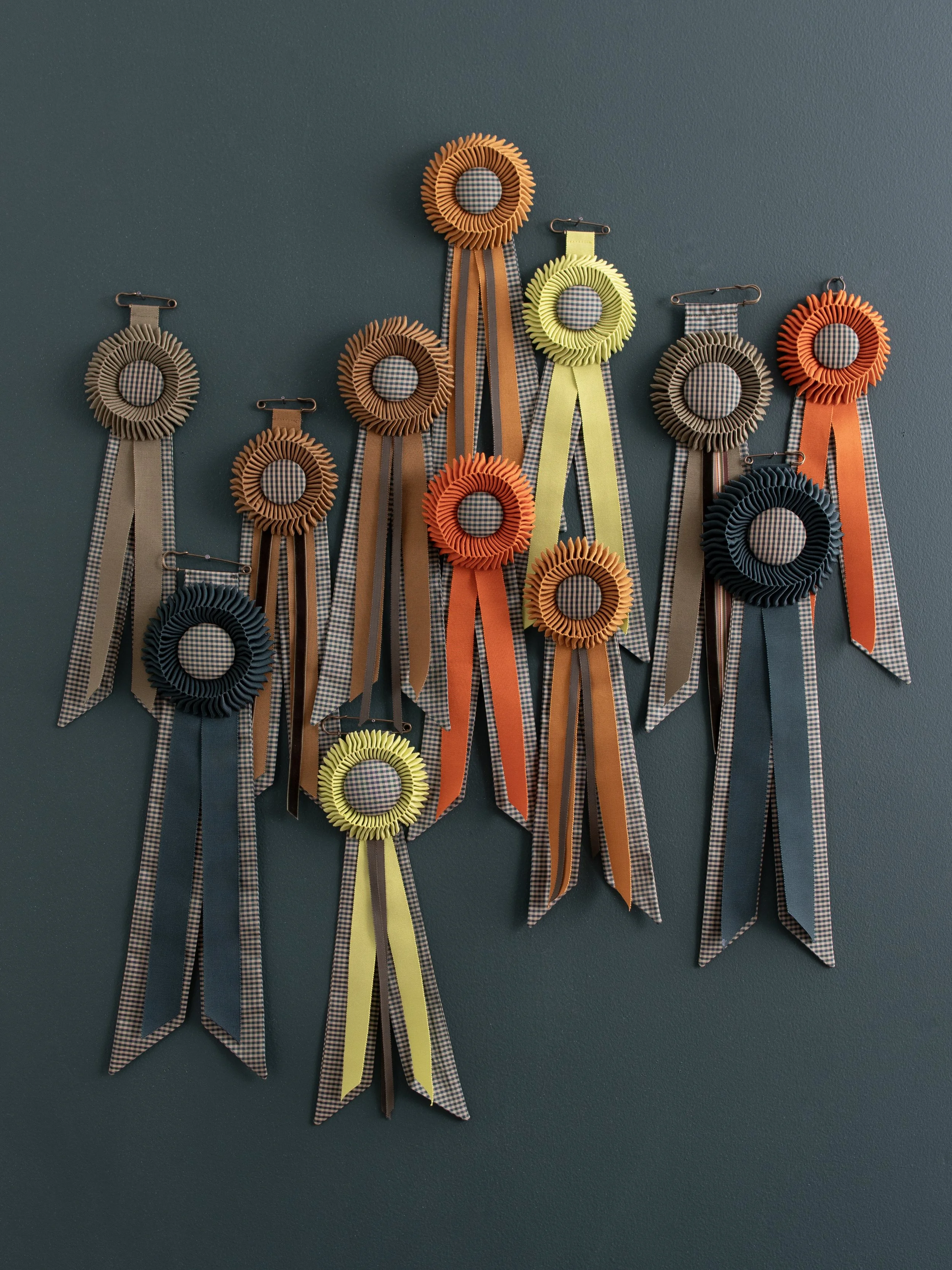 12 handmade rosettes. Created by Corrie Beth Hogg with petersham and silk
