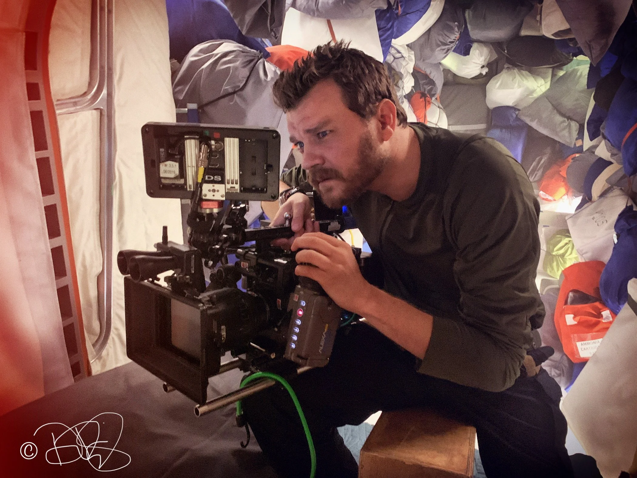 Actor Pilou Asbæk has a look through the camera during production of the feature film "ISS."