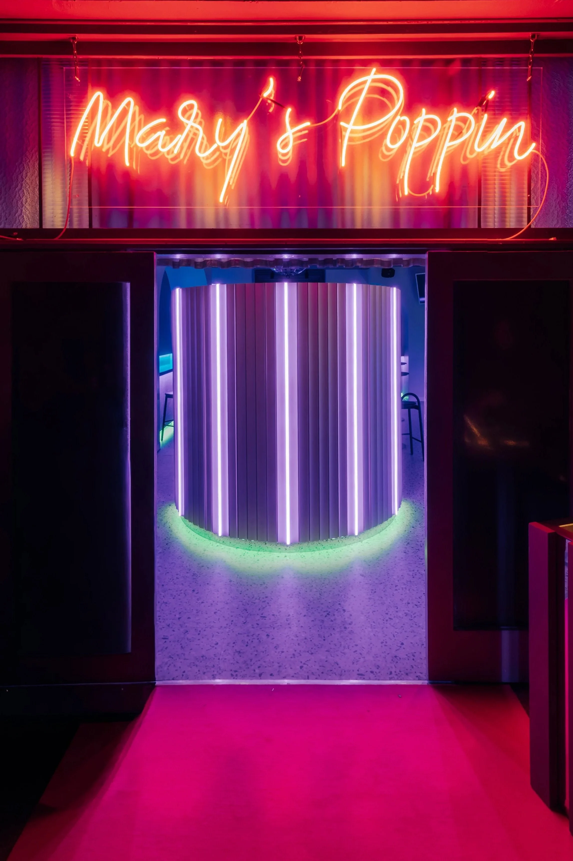 Mar's Poppin Cocktail Bar entry with illuminated curved wall