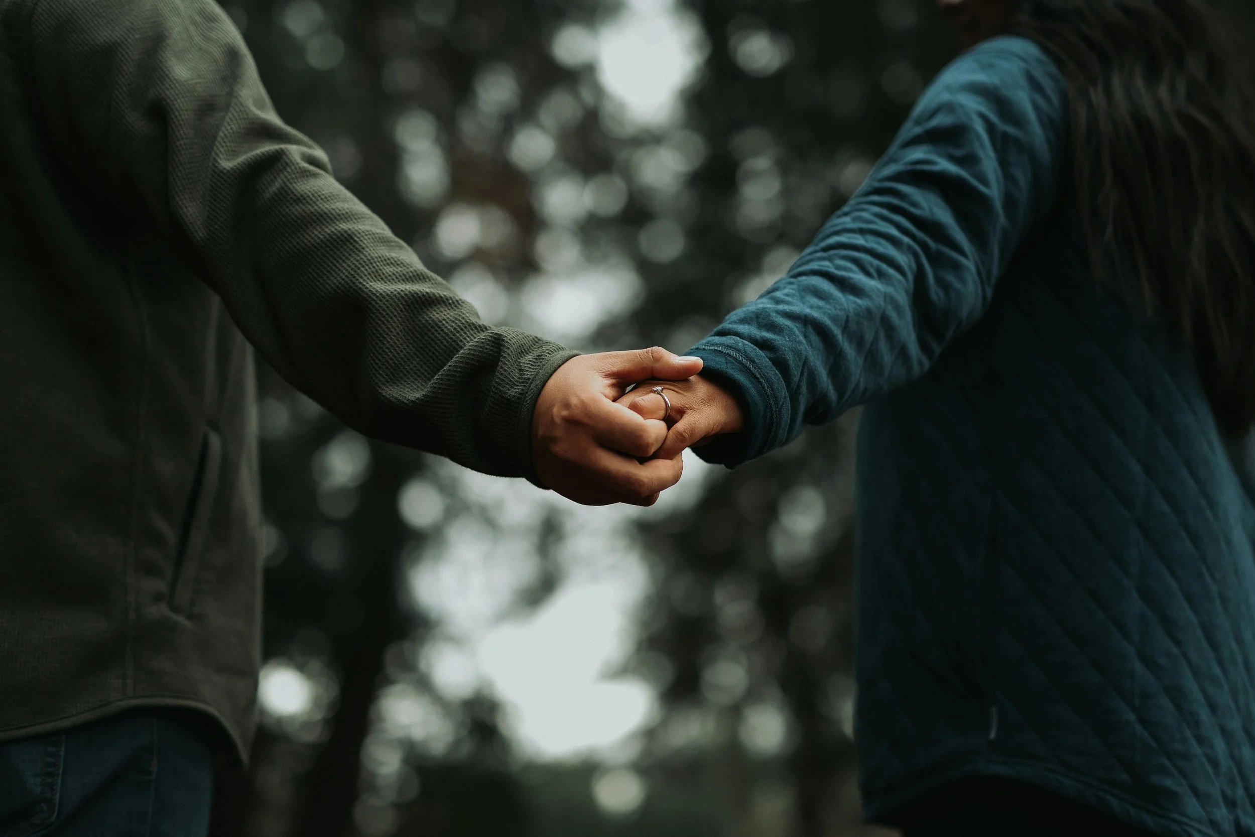 close up of two people holding hands