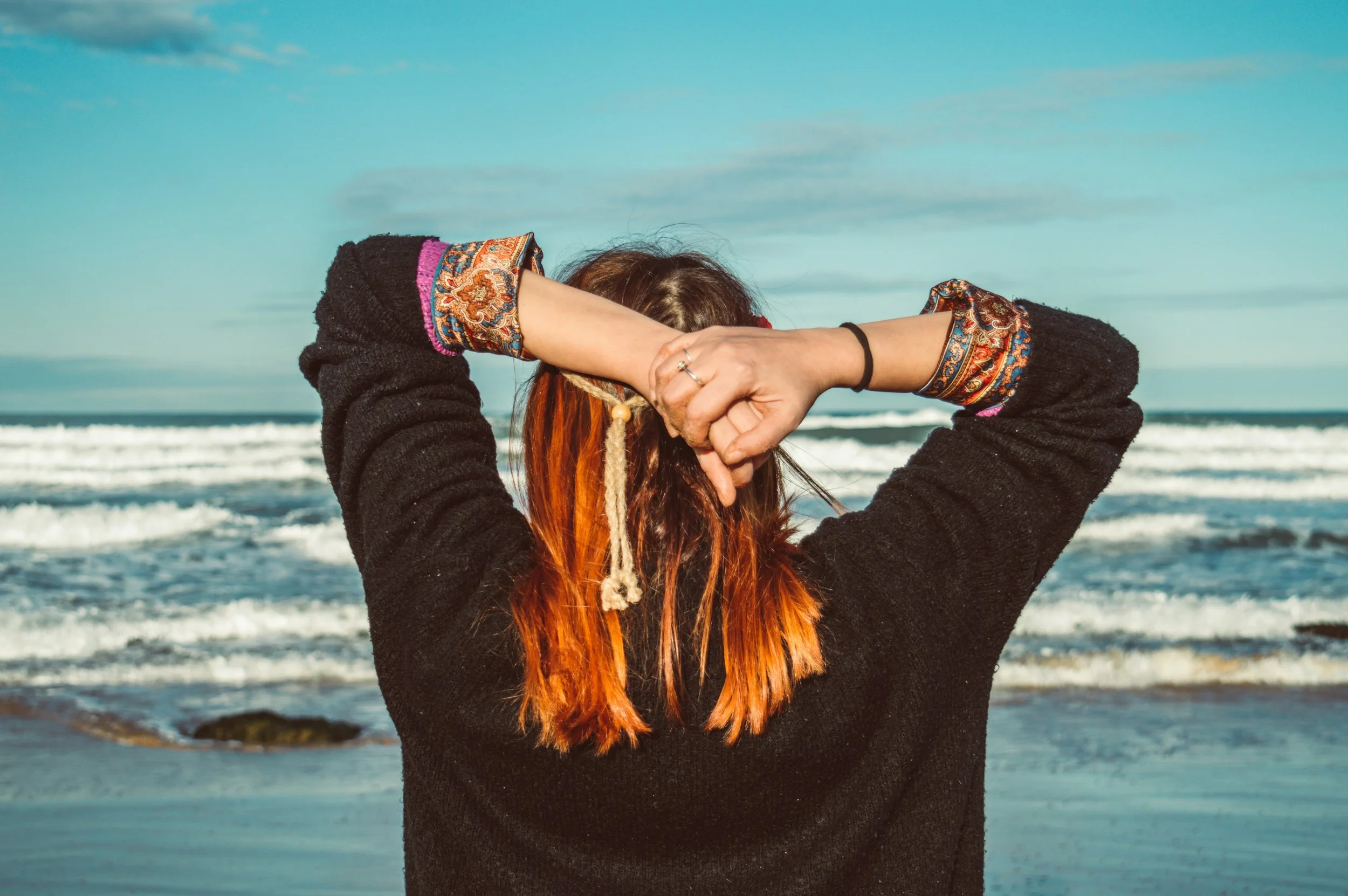 woman standing by the seashore during daytime