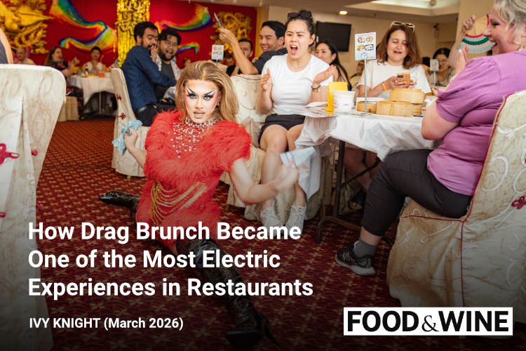 A drag queen drops down to the splits on the floor of a Chinese restaurant while surrounded by an excited audience cheering her on seated at tables full of dim sum dishes
