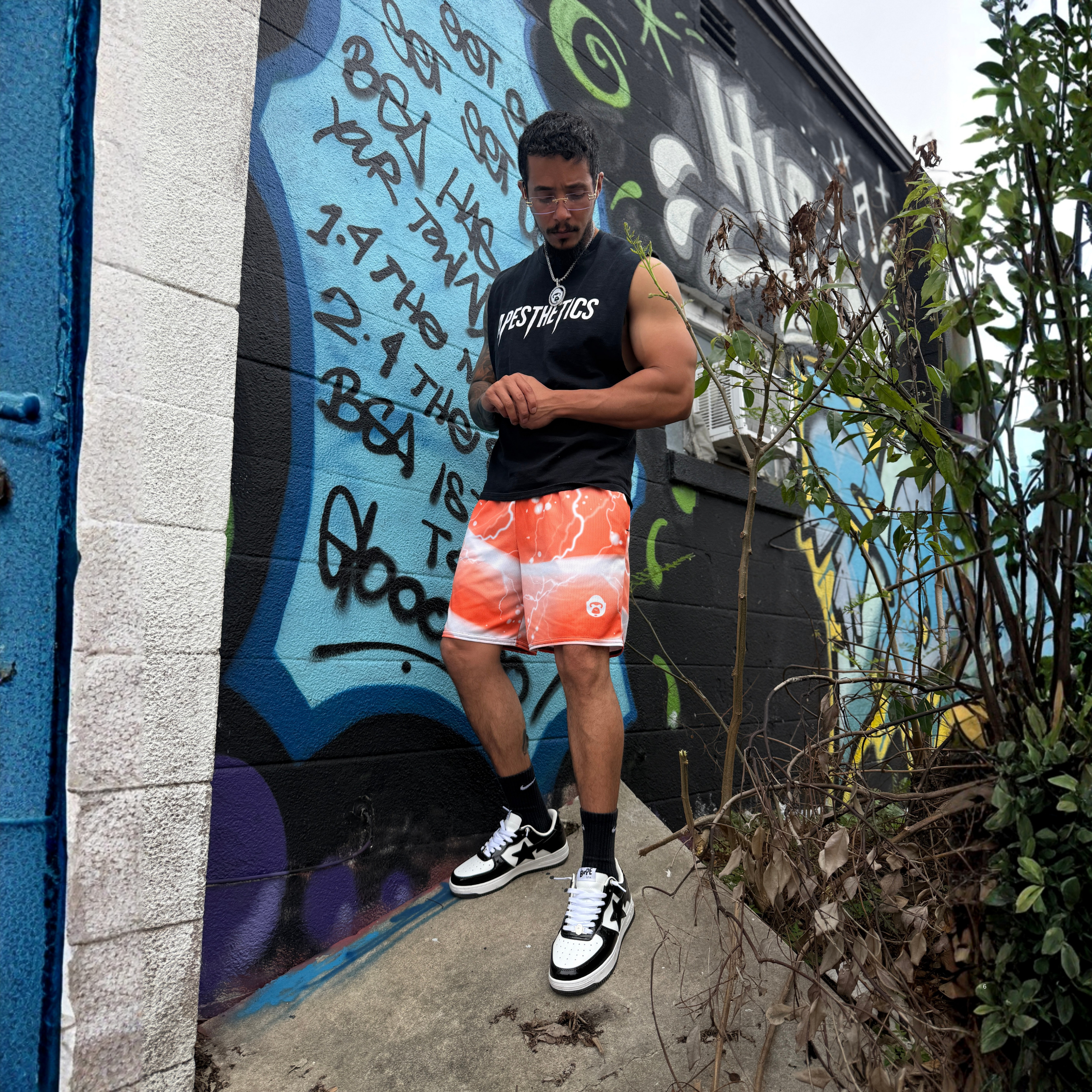 Apesthetics Gogeta orange lightning mesh shorts — men's gym streetwear