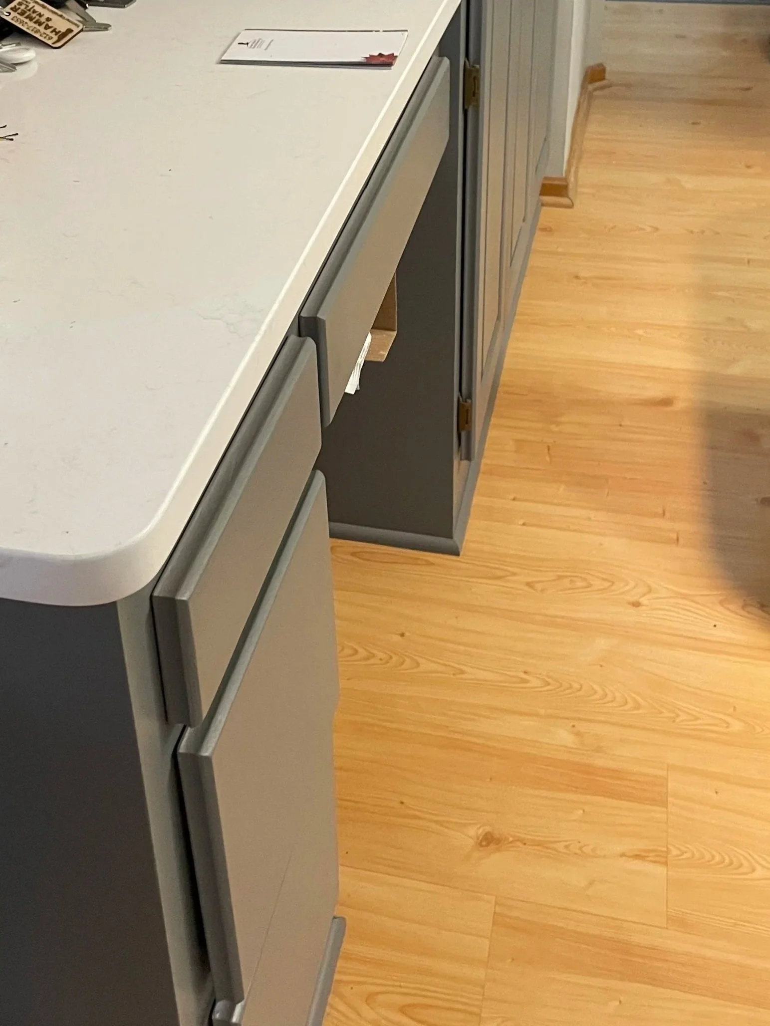 Kitchen remodel in Columbia Heights MN featuring gray cabinets, quartz countertops, and updated layout by Hammer & Nails INC.