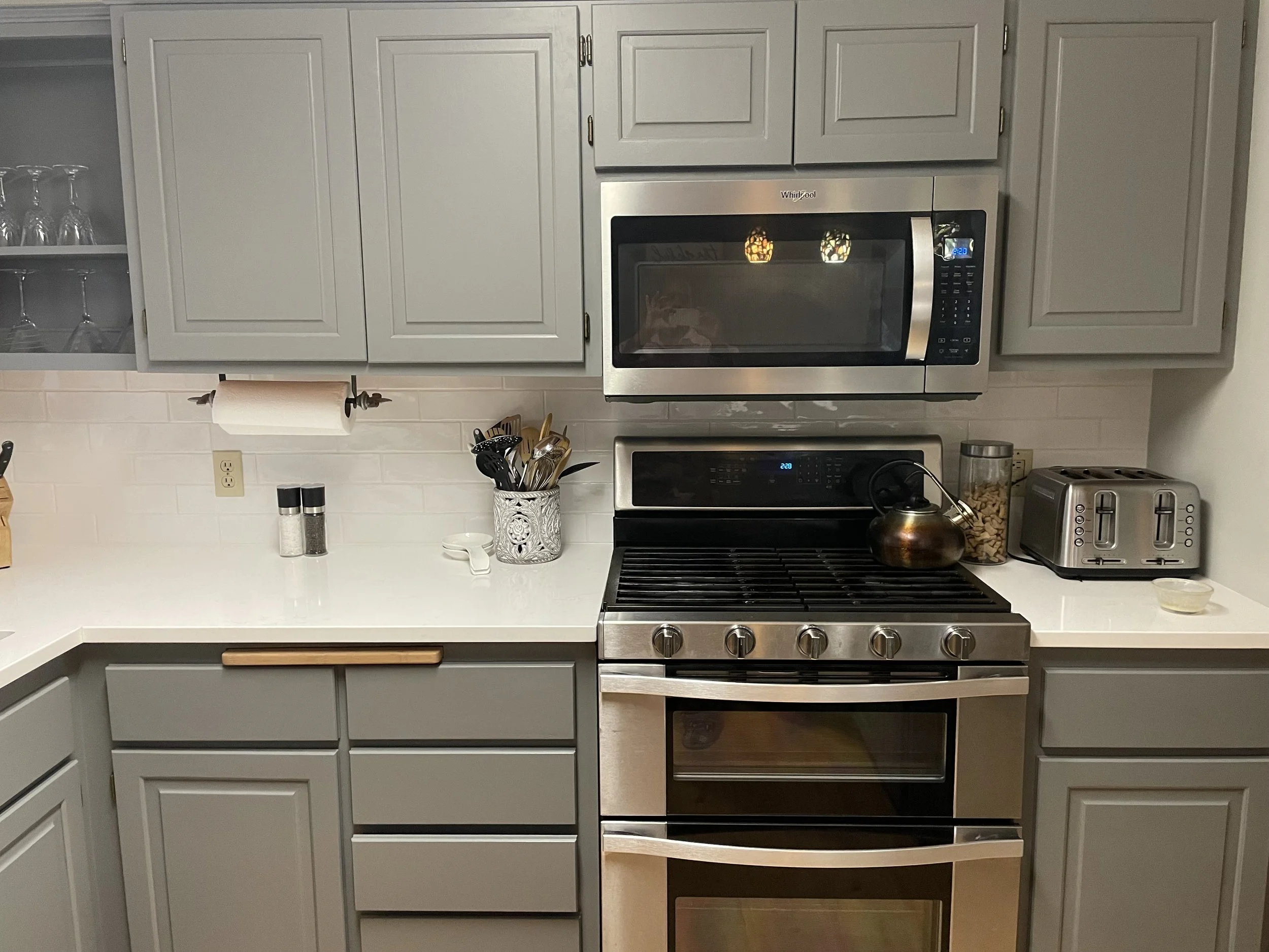 Kitchen remodel with stainless steel appliances, tile backsplash, and custom cabinetry in Columbia Heights MN.