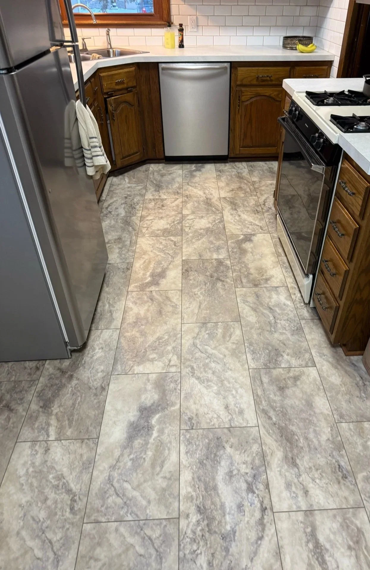 LVT flooring installation in kitchen with pebble finish in Roseville, MN