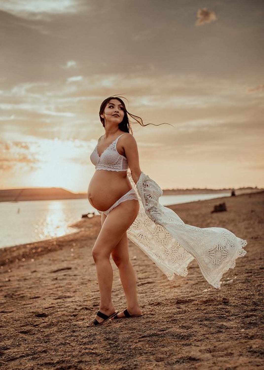 Maternity photo of of woman on shore at sunset Sacramento.jpg