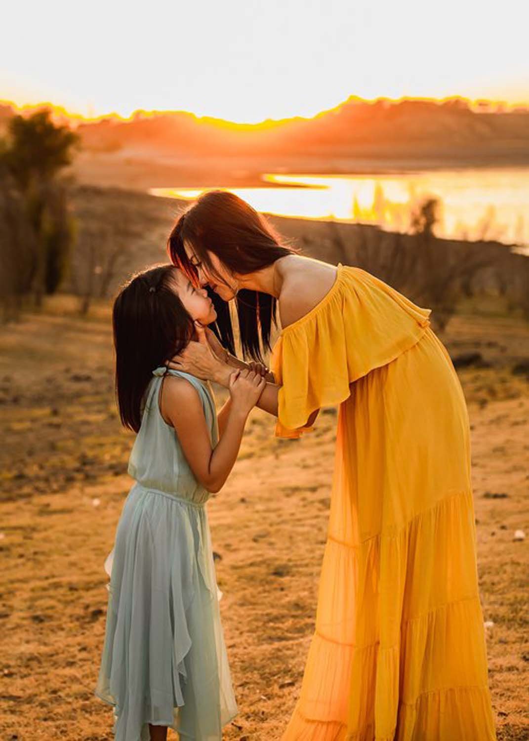 Mother face to face with daughter sunset fall family photography.jpg