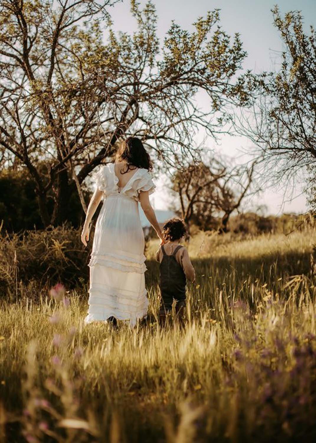 Mother walking in field with young child family photographer Sacramento.jpg