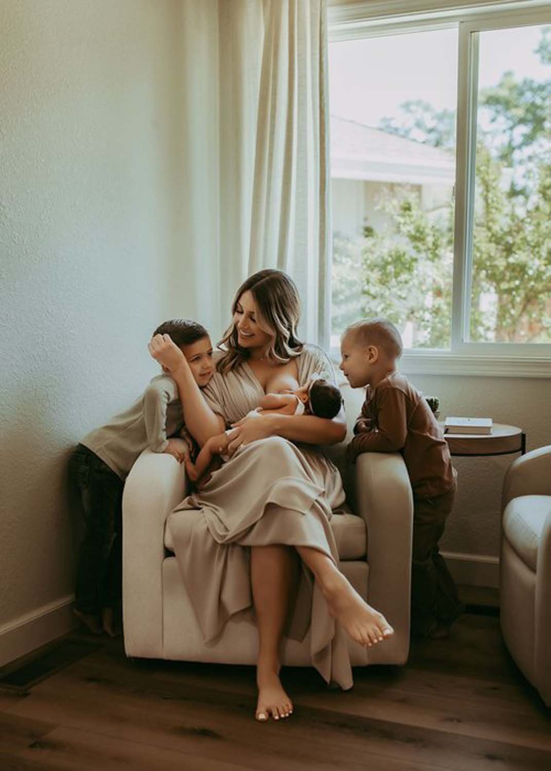 Woman with children feeding baby lifestyle family photography.jpg
