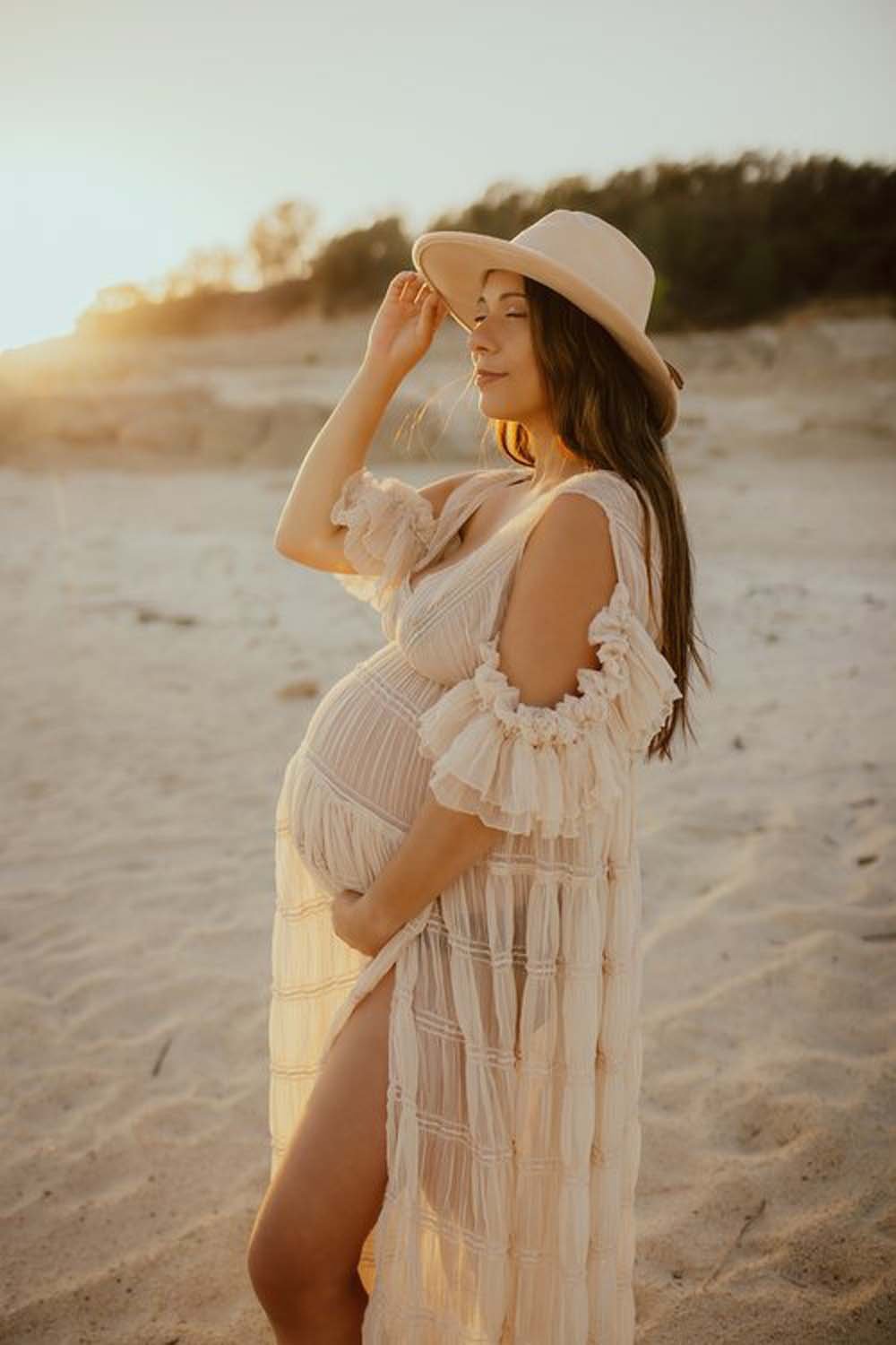 Prenant woman in sand with hat Sacramento maternity photographer.jpg