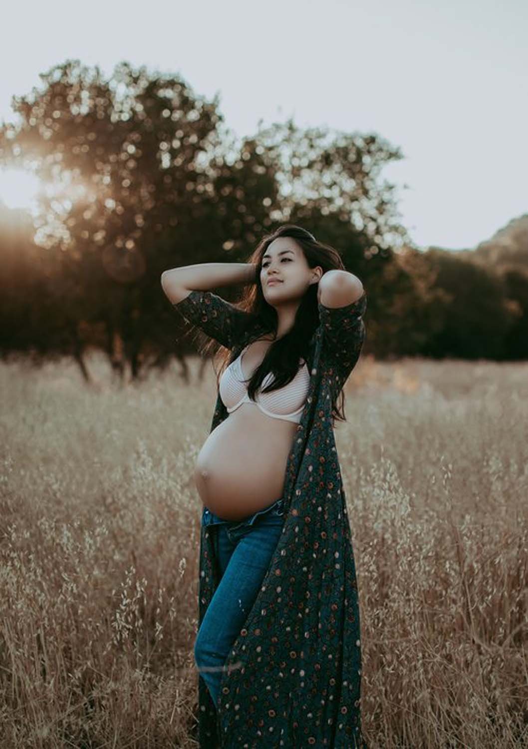 Young pregnant woman in field at sunset Sacramento pregnancy shoot photos.jpg
