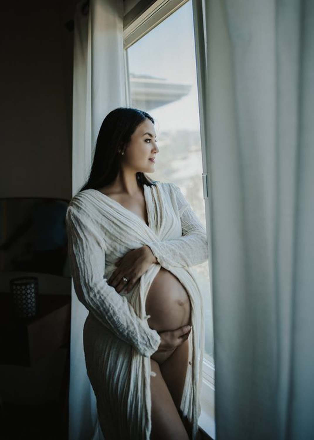 Mother to be looking out window pregnancy shoot photos.jpg