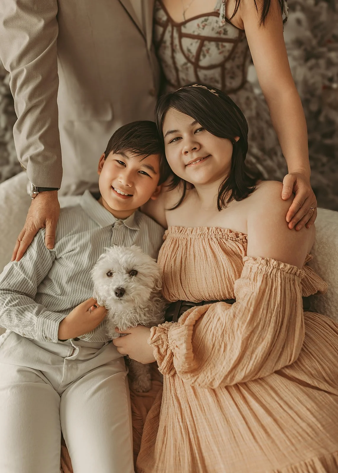  two children, dressed in their Sunday best clothing pose for Christmas Petite session in Sacramento Ca 