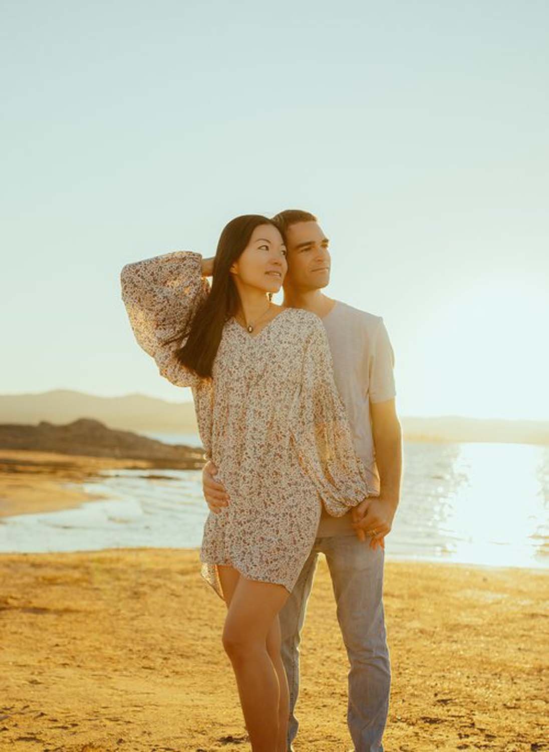 Young couple standing by water at golden hour Sacramento family photo studio.jpg