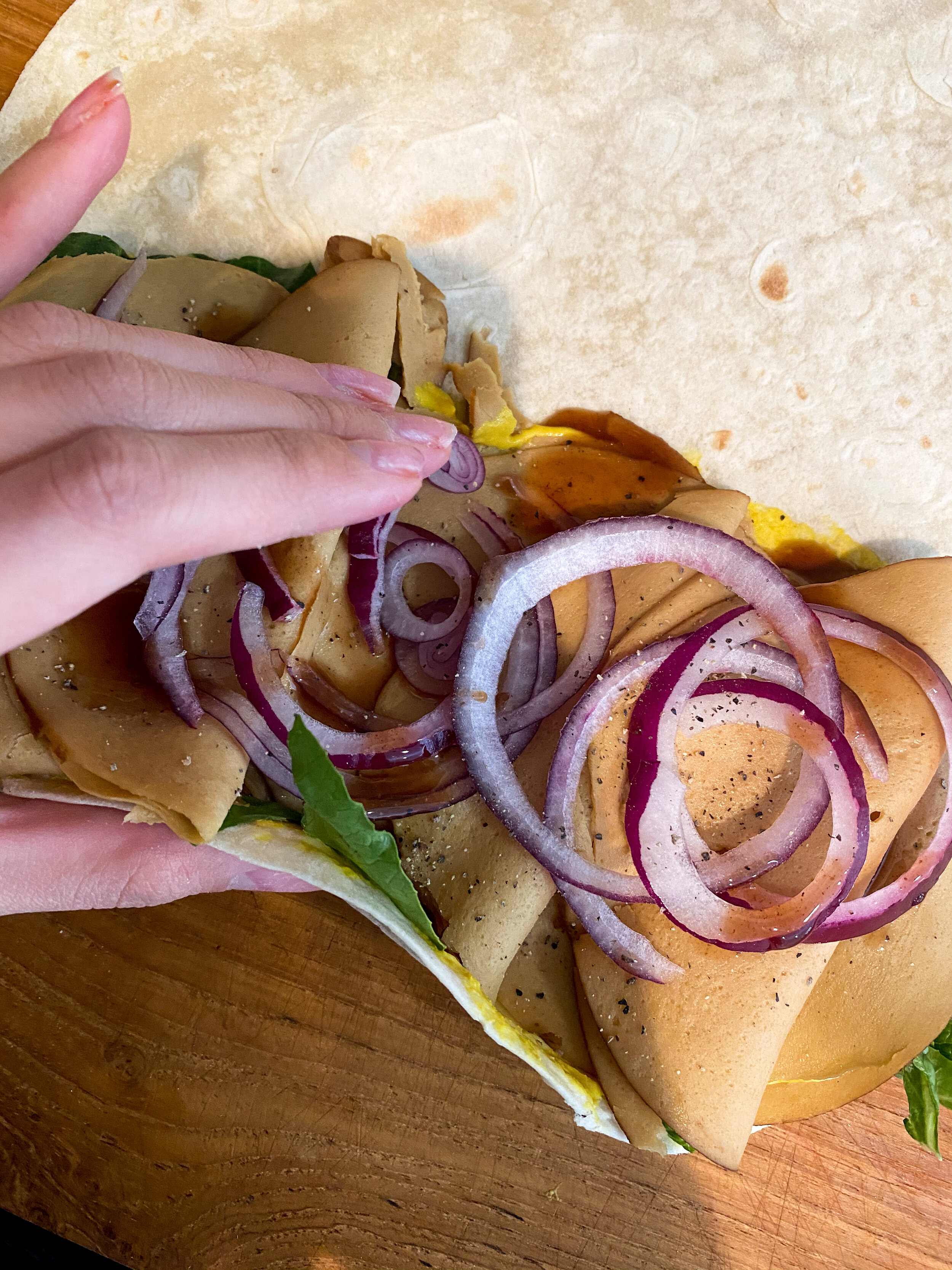 I tried to take the best photo I can of the beginning of the rolling process. With both hands lift under the tortilla while placing your fingers on top of the food (be sure your hands are clean) and just start rolling it to the other side, as tight …