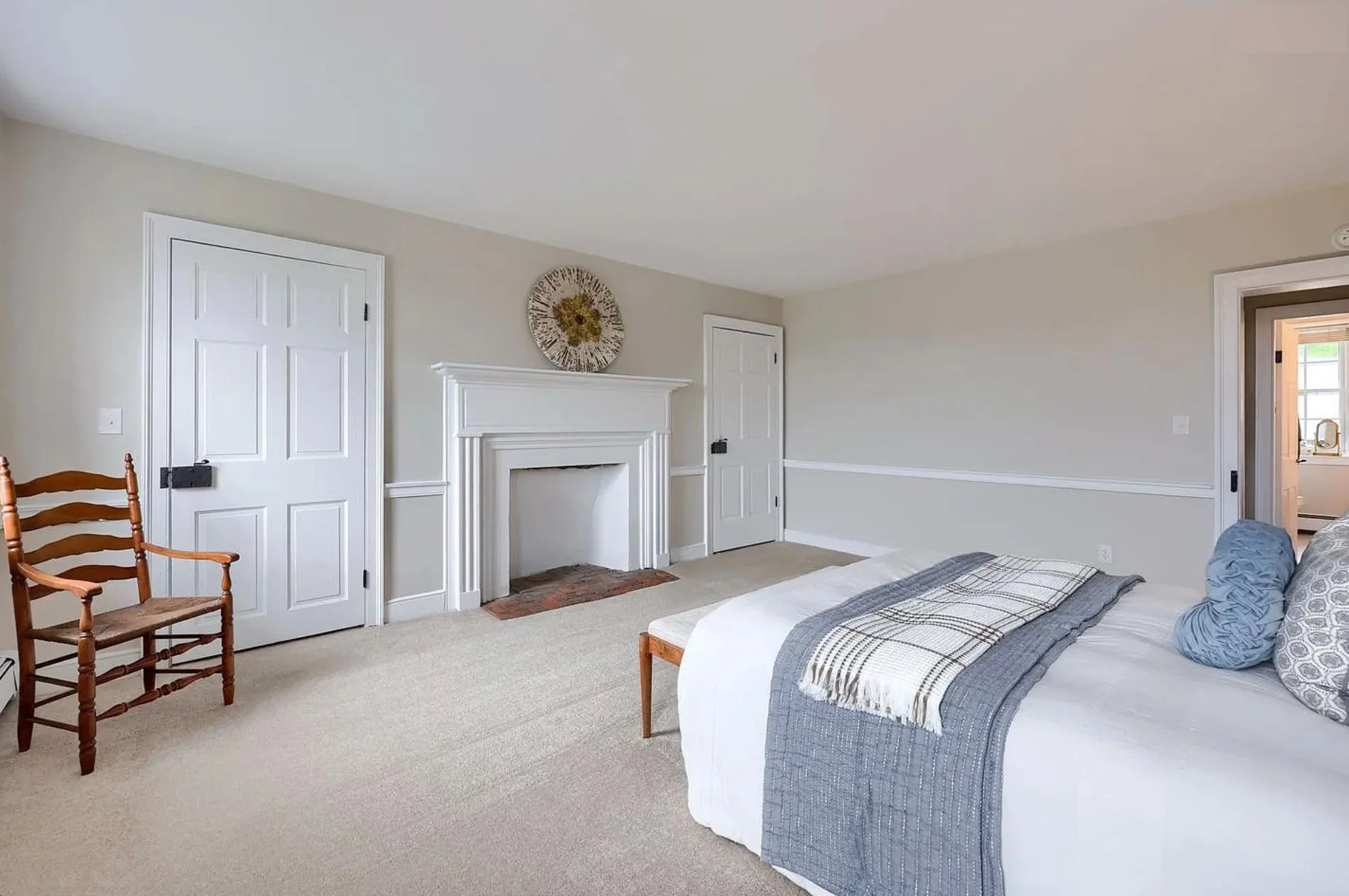 Professionally staged bedroom in a Columbia, PA Colonial Farmhouse featuring layered bedding, soft neutral décor, and an inviting atmosphere.