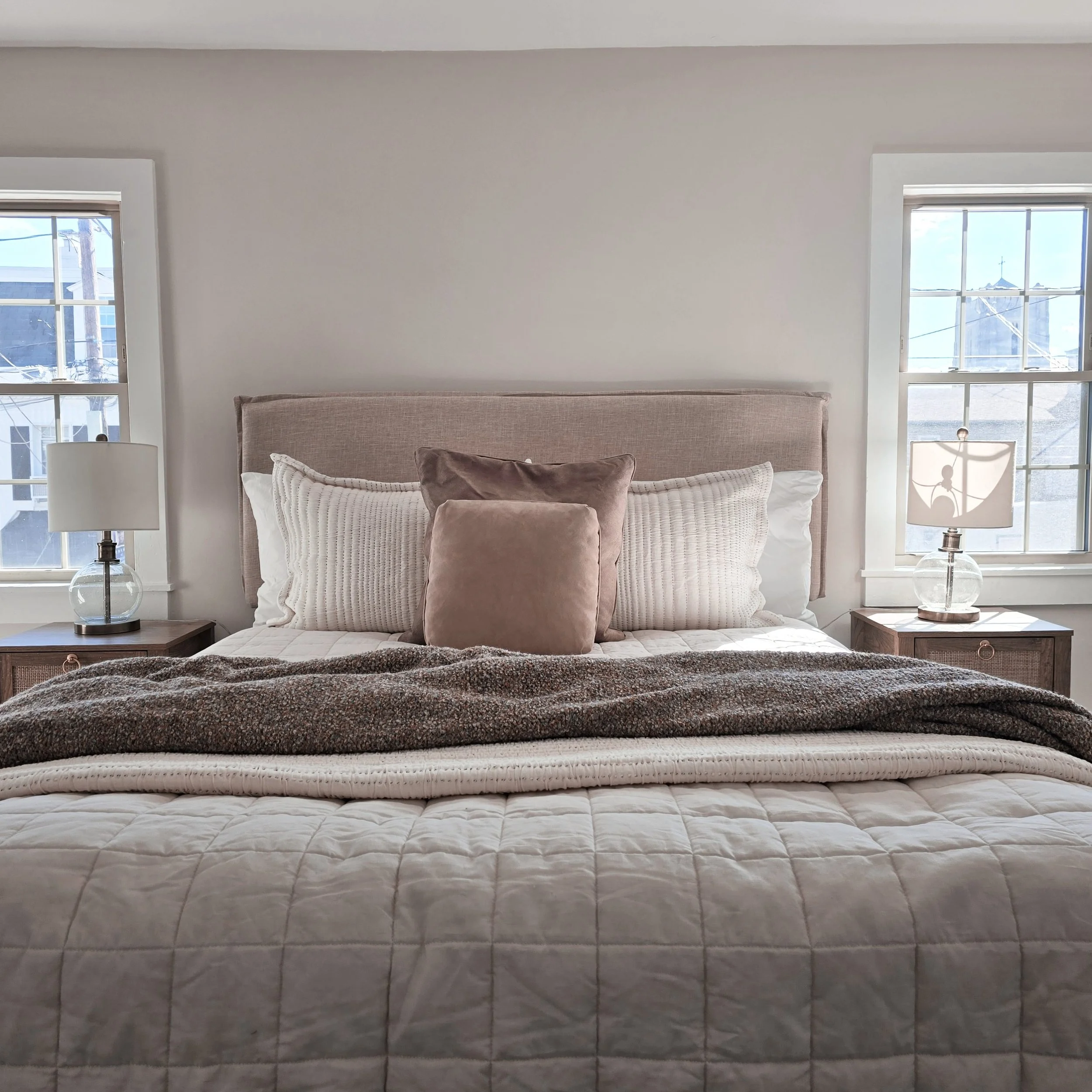 Professionally staged bedroom in a Columbia, PA home featuring layered bedding, neutral décor, and a warm, inviting atmosphere.