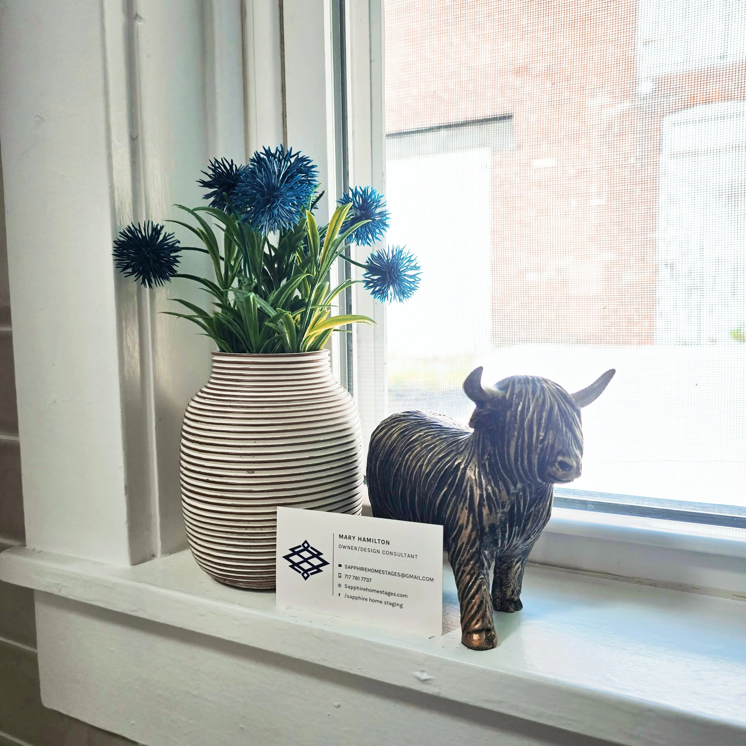 Styled window sill featuring decorative accents and a Sapphire Home Staging business card in a Columbia, PA home.